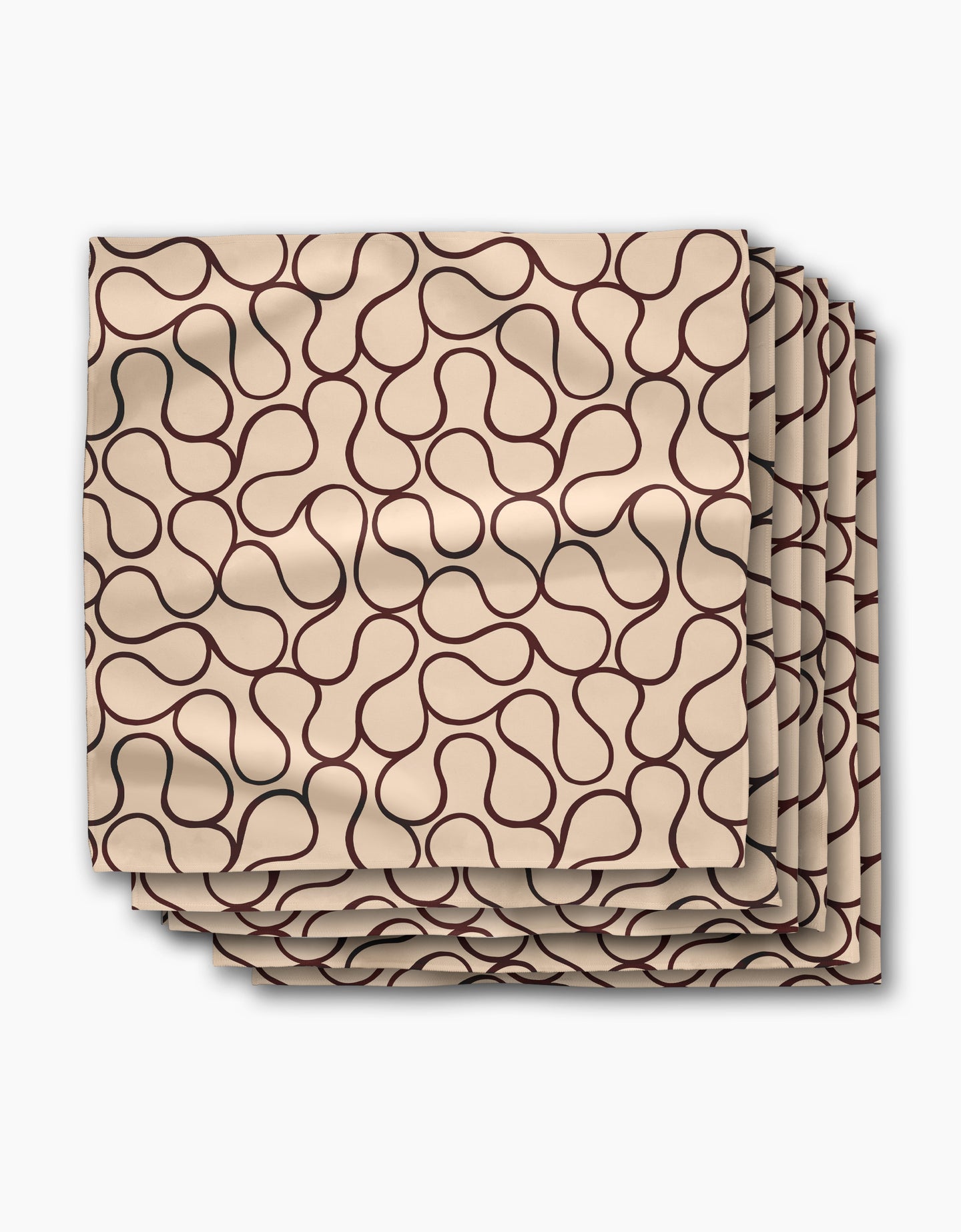 A set of four Gerdadzy Coffee Swirl dinner napkins in beige Geosuede fabric, each with a dark brown abstract line pattern, neatly stacked with slight overlap on a white background.