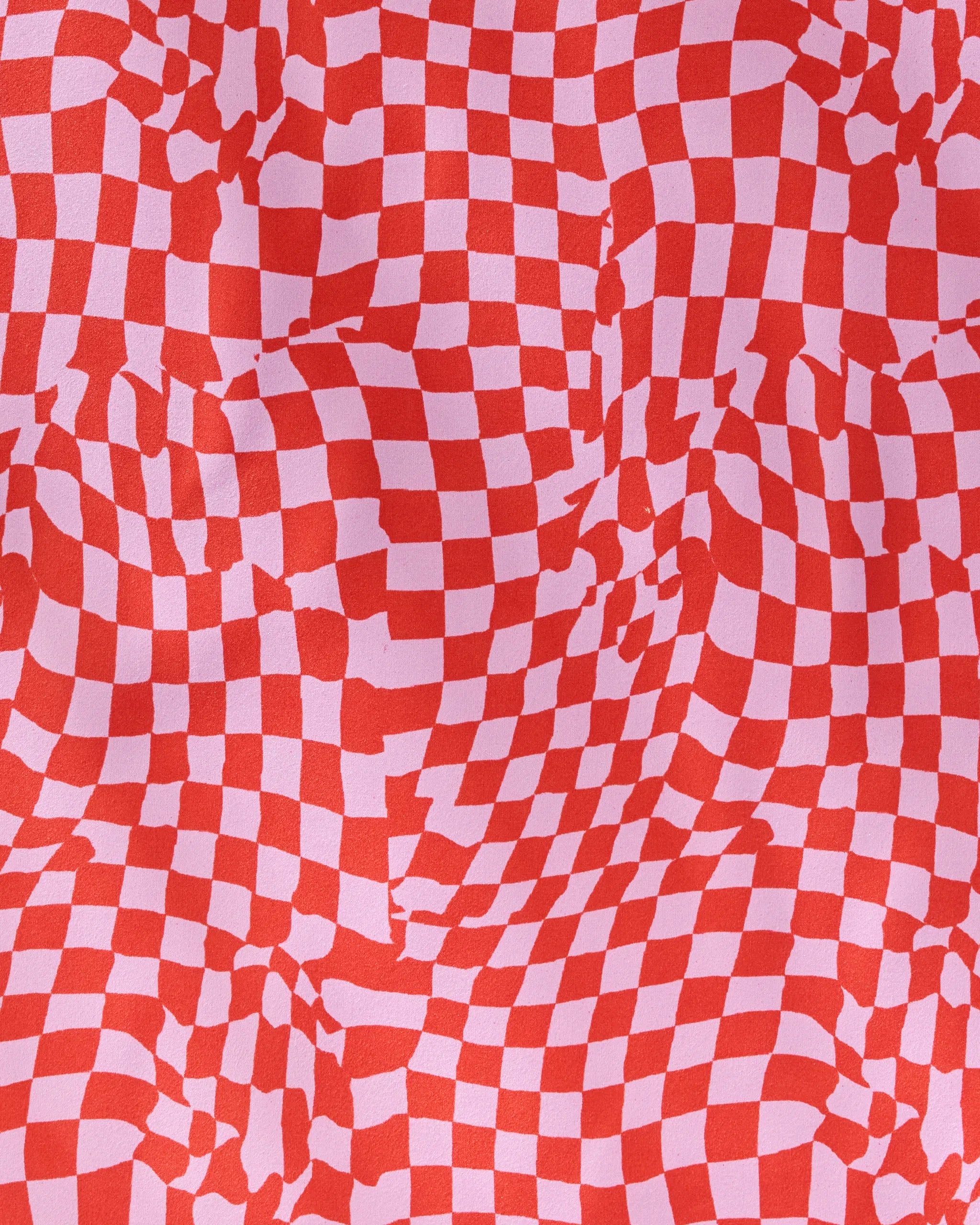 Geometry’s “Distorted Love” features a wavy red and pink checkerboard pattern with distorted squares—an eye-catching optical illusion, ideal for adding bold style to any reusable napkins or dinner napkin set.