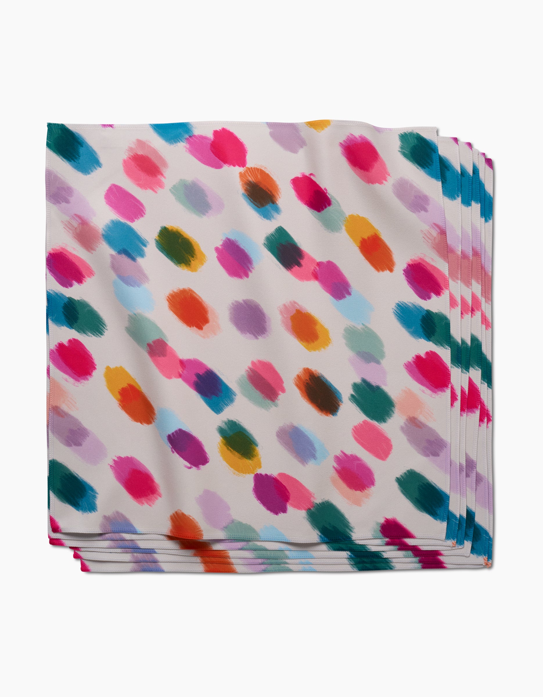 Downpour Dinner Napkins by GEOMETRY are made from recycled materials and showcase colorful, irregular paintbrush dots in pink, orange, blue, green, and purple on a white background.