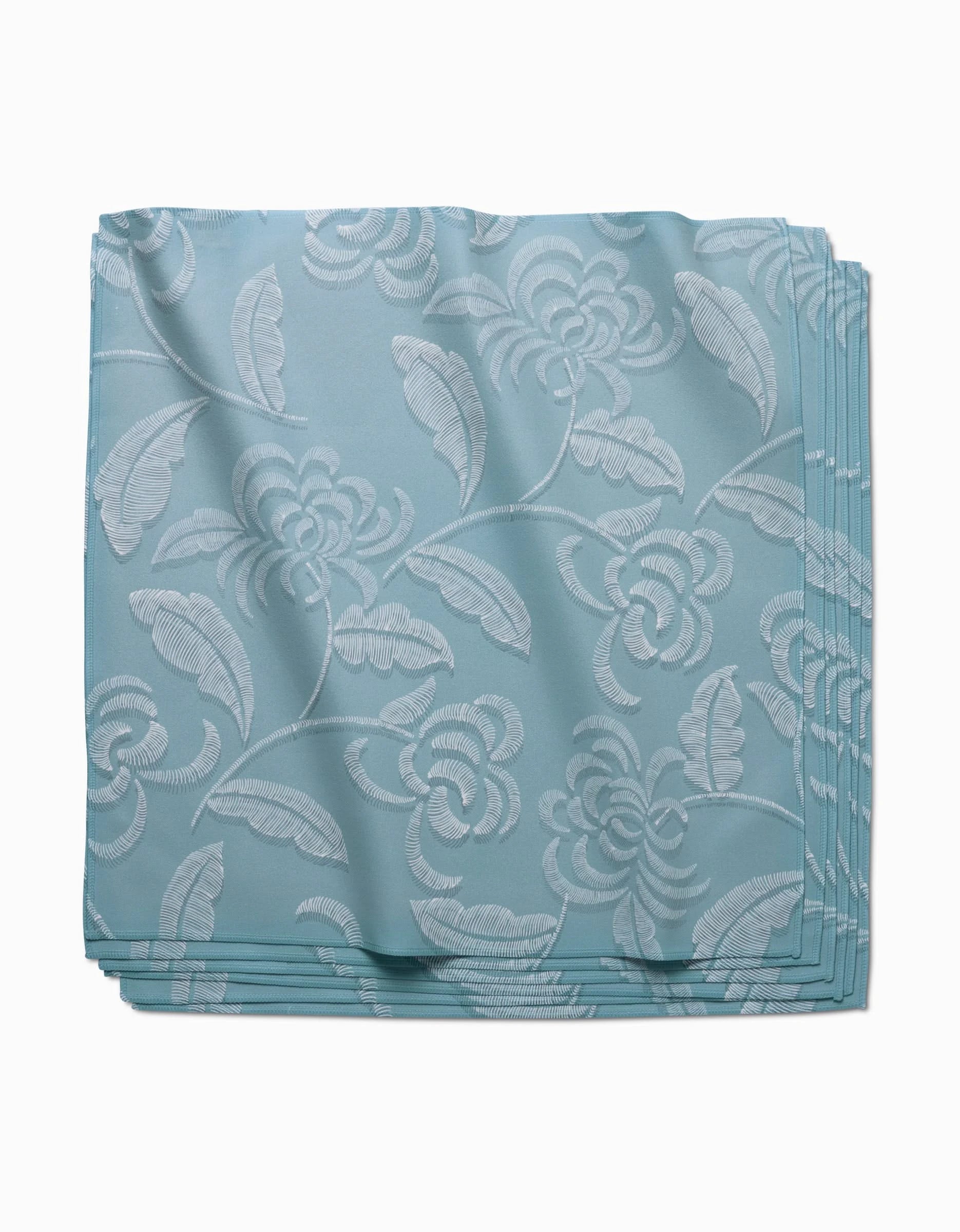 The GEOMETRY Ediths Embroidery Dinner Napkin Set in light blue features a subtle white floral and leaf pattern on eco-friendly Geosuede fabric, displayed neatly folded against a white background.
