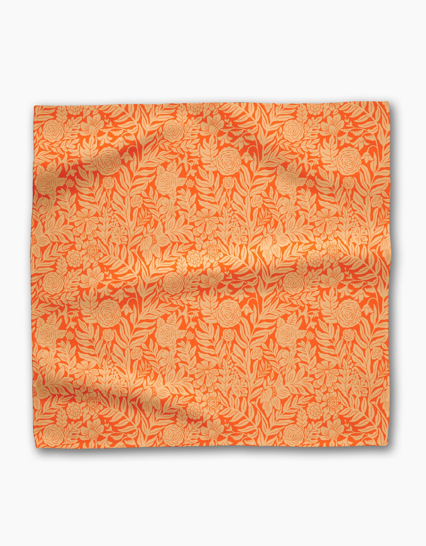 The Florence fabric by Katie OShea features an orange background with a detailed beige floral and leaf pattern, making it ideal for eco-friendly or recycled dinner napkin sets. Its surface is slightly wrinkled and laid flat on white.