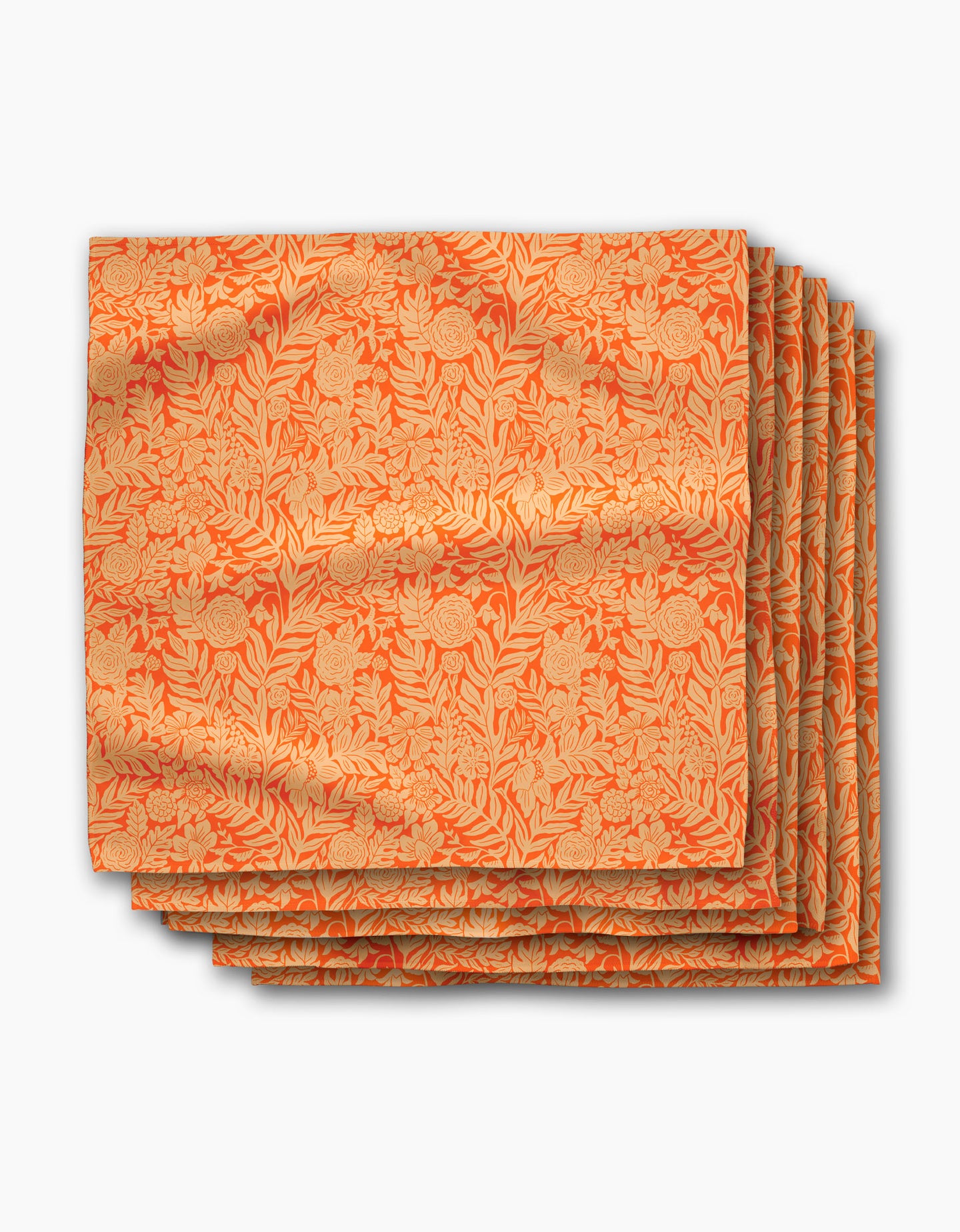 The Florence napkins by Katie OShea are six neatly stacked, eco-friendly orange napkins with a gold floral and vine pattern—stylish dinner décor for any occasion, beautifully displayed against a white background.