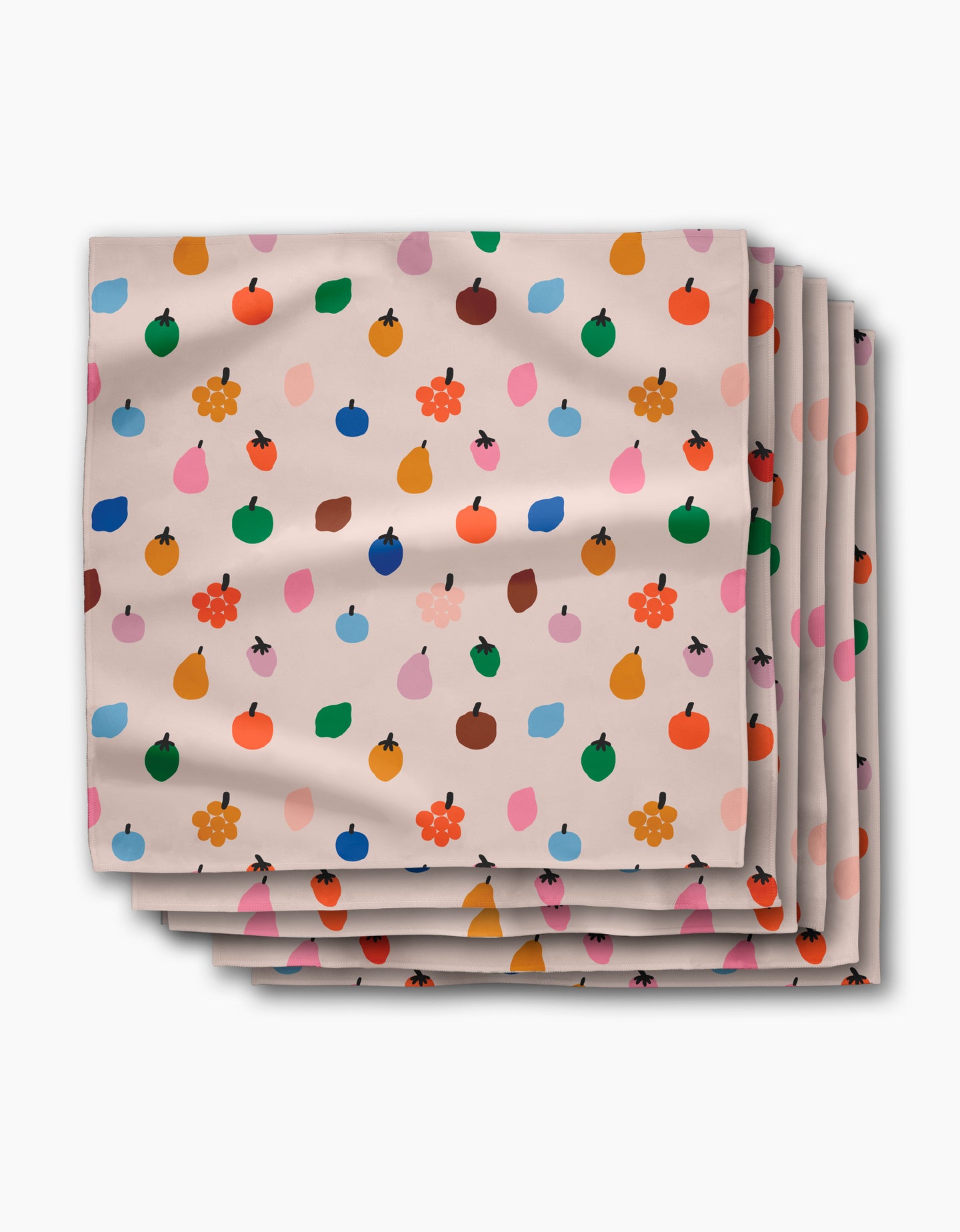 The Jennifer Bouron Fruit Basket Dinner Napkin Set features beige Geosuede™ napkins adorned with vibrant fruit and flower patterns in red, blue, orange, green, and pink.