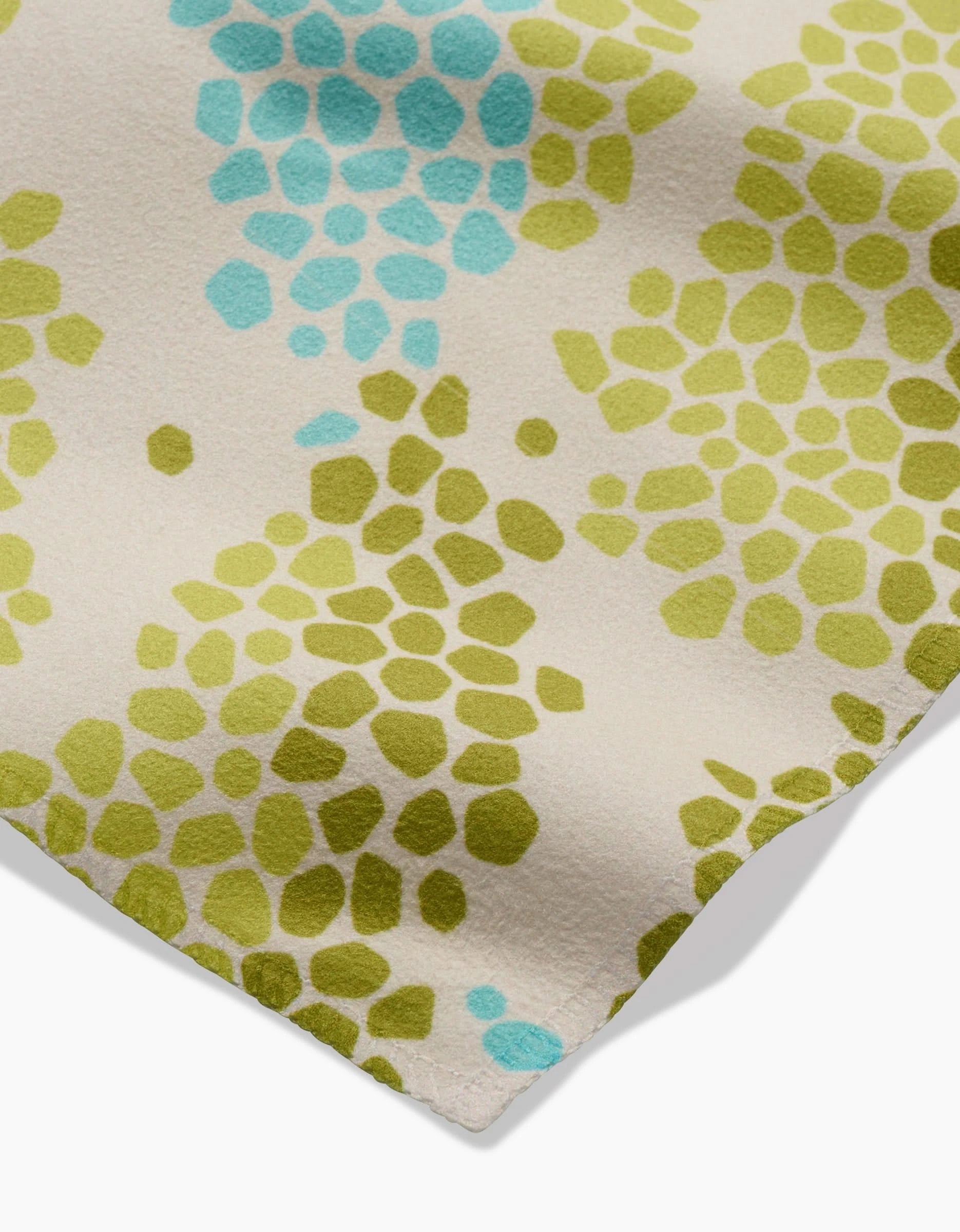 Geo Shell by GEOMETRY features a cream background with green and light blue abstract pebble-like patterns—perfect for creating recycled dinner napkins or an eco-friendly Dinner Napkin Set.
