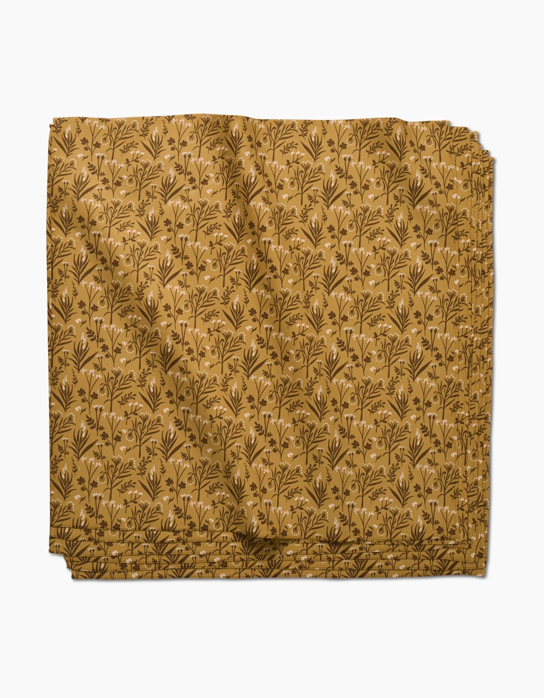 Golden Fall Flowers by Danelys Sidron features a mustard yellow fabric with a brown leafy print; this eco-friendly napkin adds charm to your table and comes as part of a recycled dinner napkin set.