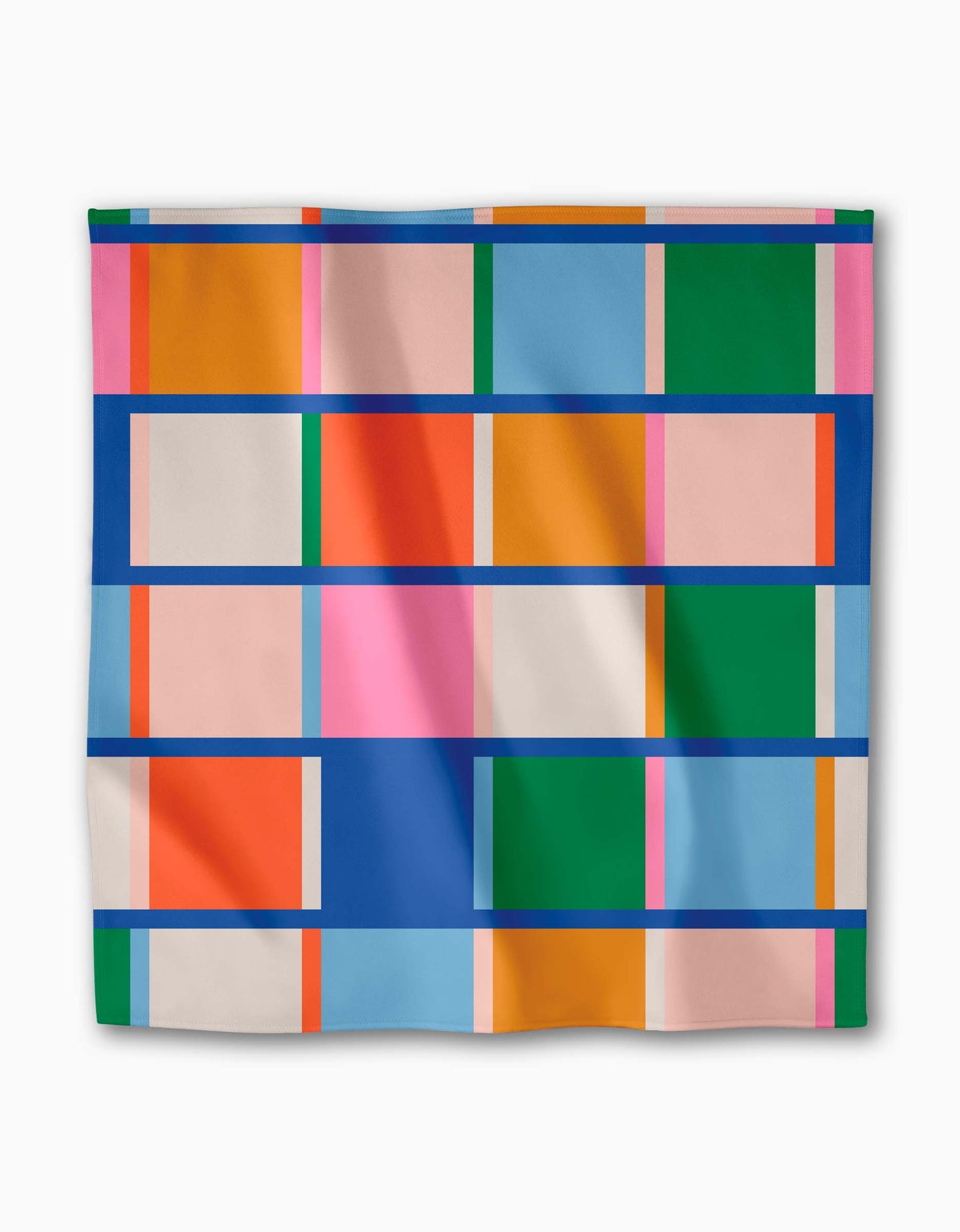 The Grid Dinner Napkin by Jennifer Bouron showcases a geometric pattern of orange, green, blue, pink, and beige rectangles and squares with bold blue lines on white Geosuede fabric.