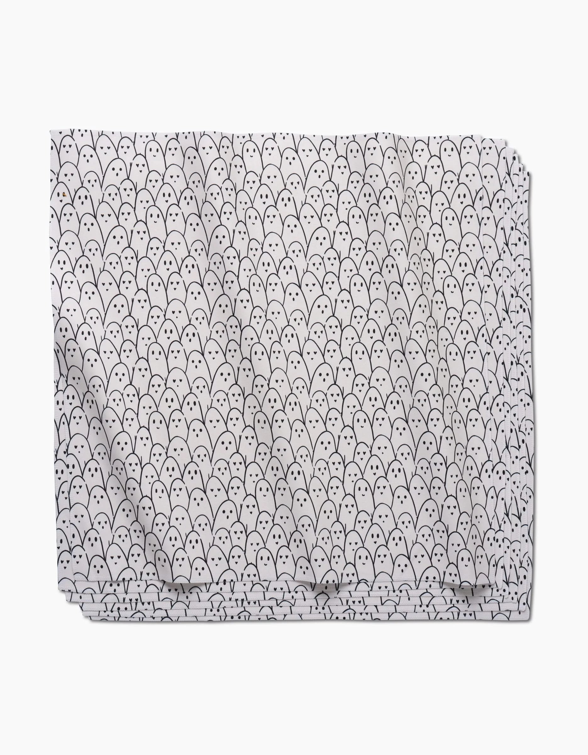 Happy Ghosts by Hufton Studio is an eco-friendly white dinner napkin featuring a playful, whimsical pattern of small black ghost faces with round eyes and oval mouths.