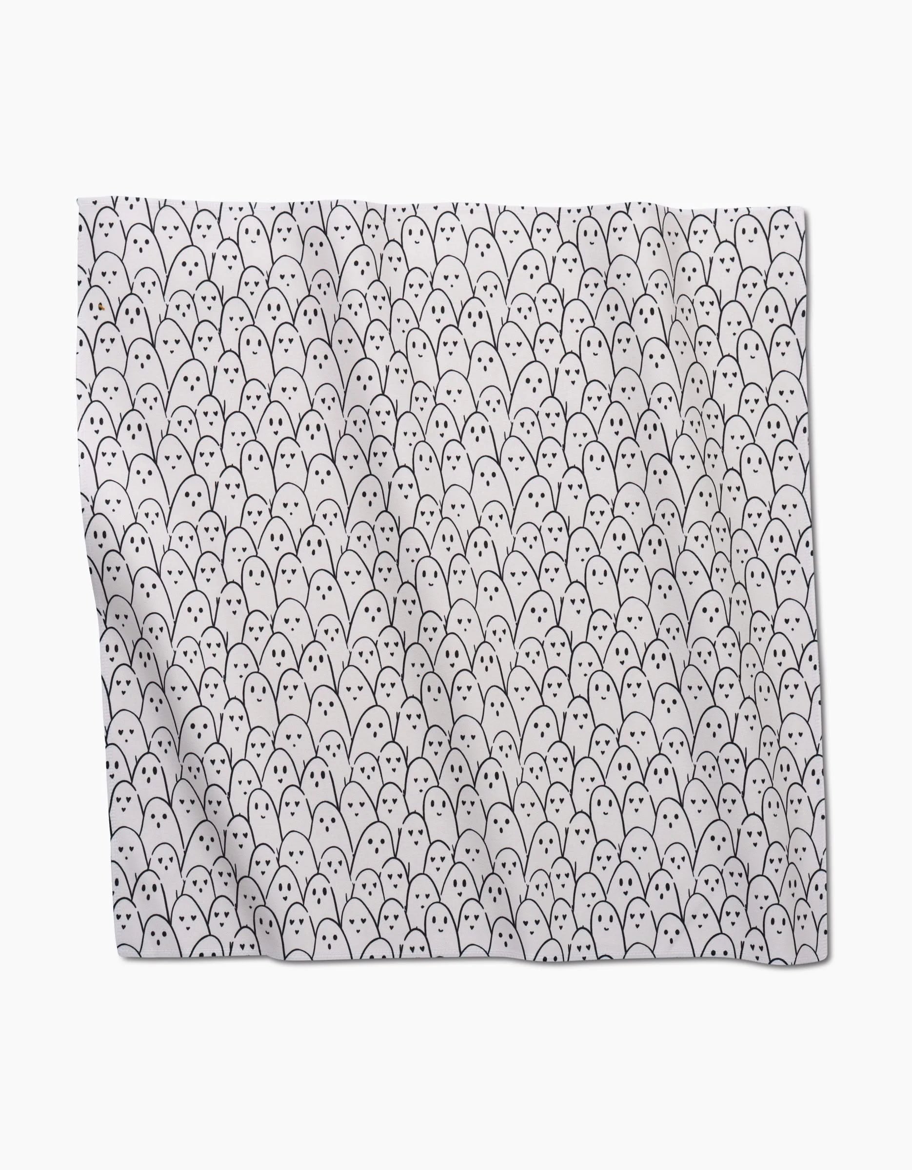 The Happy Ghosts blanket by Hufton Studio features a playful pattern of simple, cartoon-like white ghost faces on a plain background, inspired by the cute eco-friendly napkin designs.