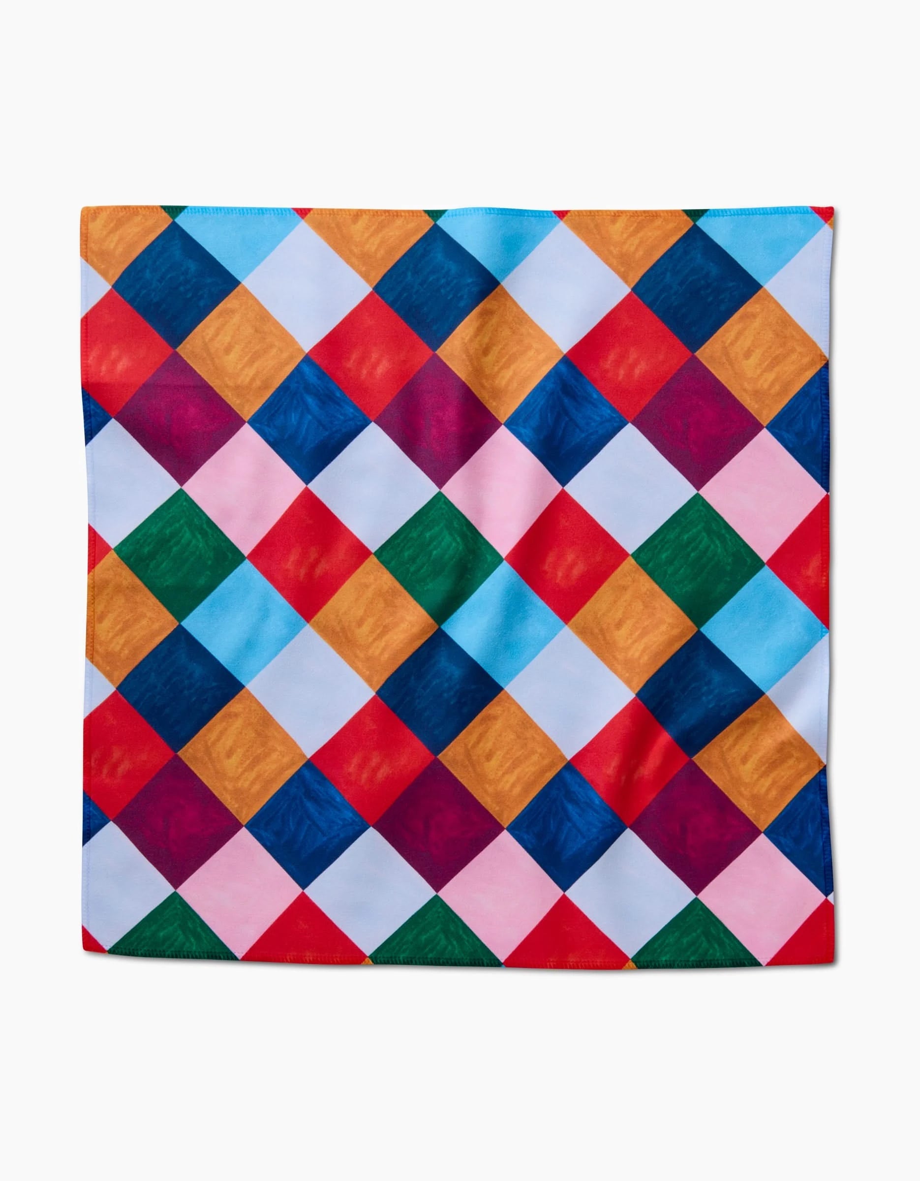 The Holiday Harlequin by Daria Solak is a square reusable napkin featuring a vibrant diamond-checkered pattern in blue, red, yellow, green, pink, and white.