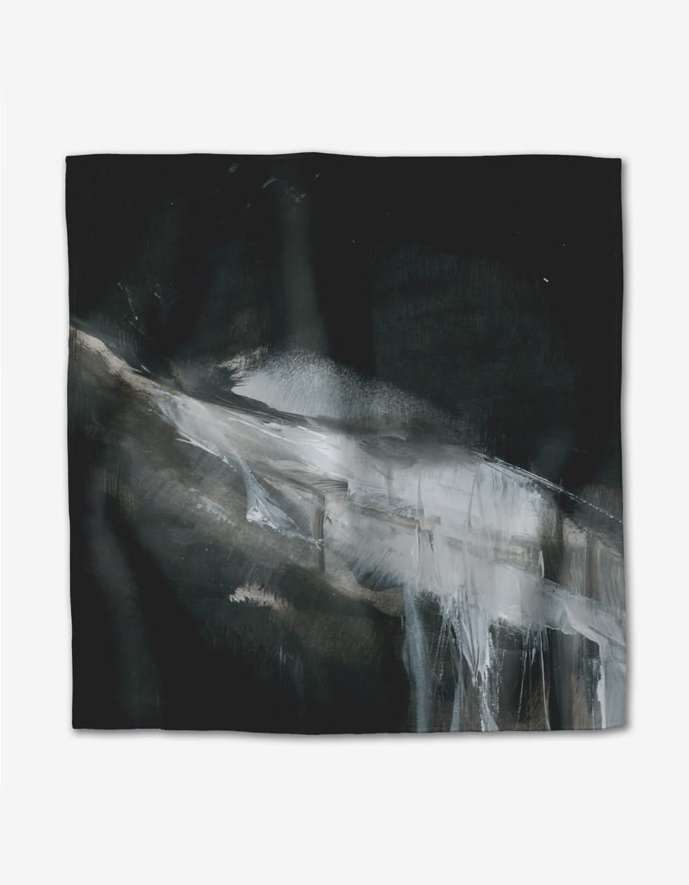 “Icelandic Elements” by Jennifer Janesko features a dark Geosuede square with abstract white and gray brushstrokes on black, creating a dynamic pattern—ideal for stylish dinner napkins.