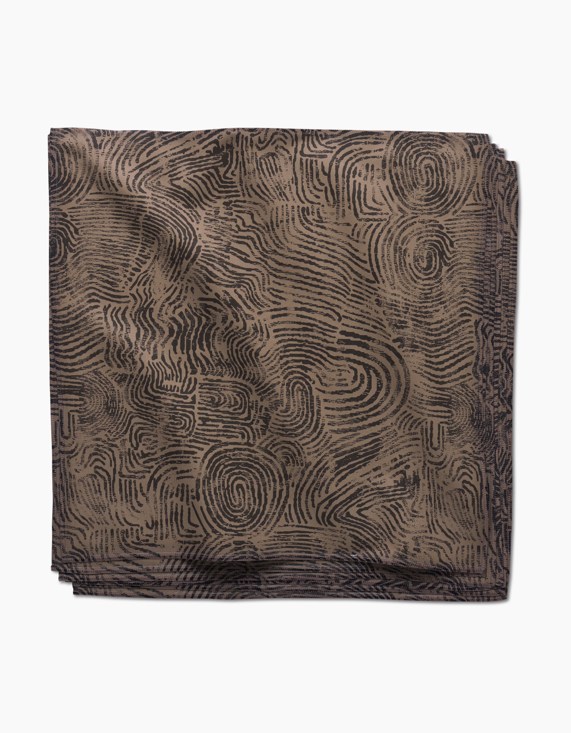 The Imprint Dinner Napkin Set by Studio Jeannot features folded square napkins in Geosuede fabric with a brown base and black abstract maze-like lines, displayed on a white background.