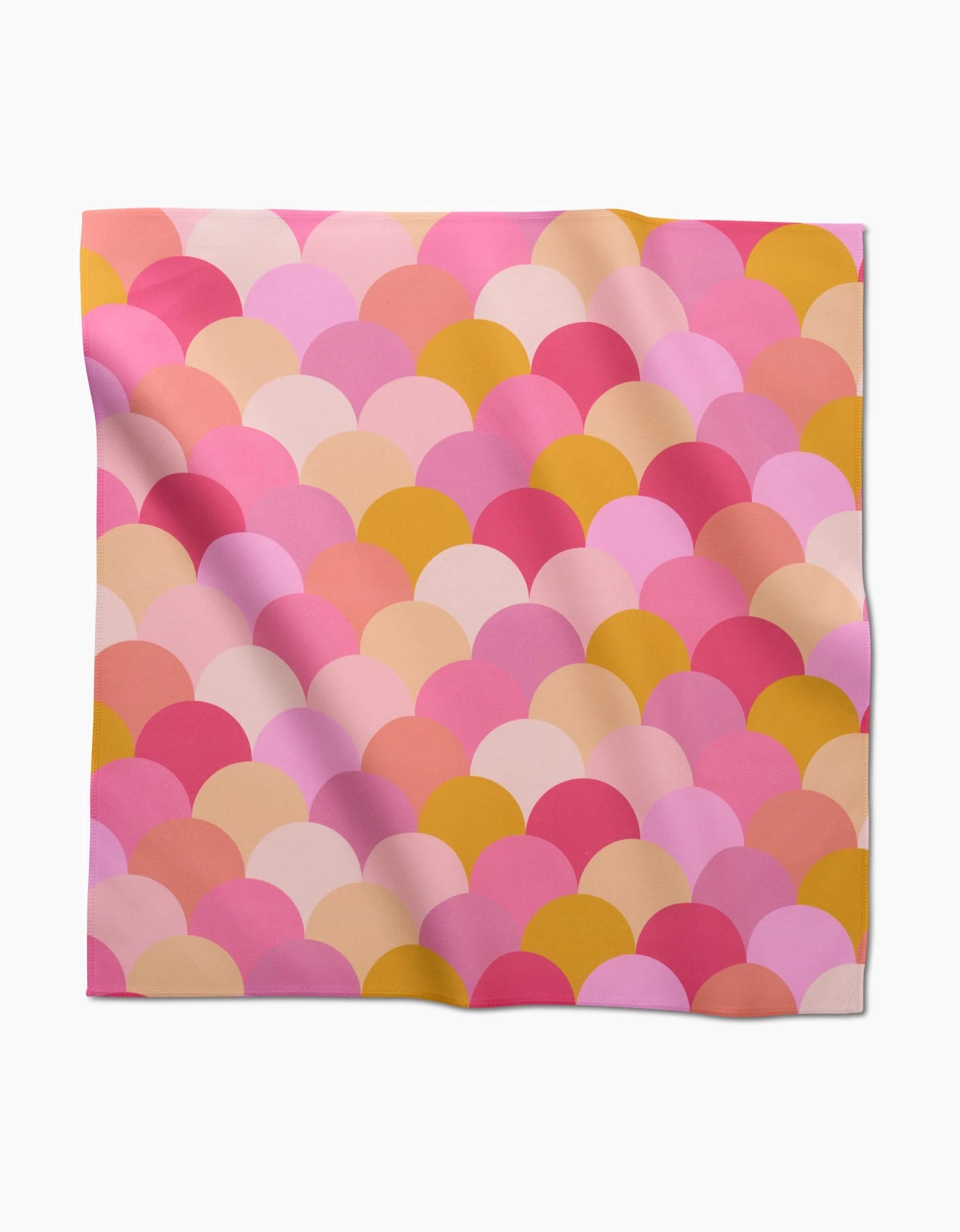The GEOMETRY Inherit is a square scarf crafted from eco-friendly Geosuede, featuring a scallop pattern in pink, peach, red, and mustard yellow on white with subtle folds and waves.