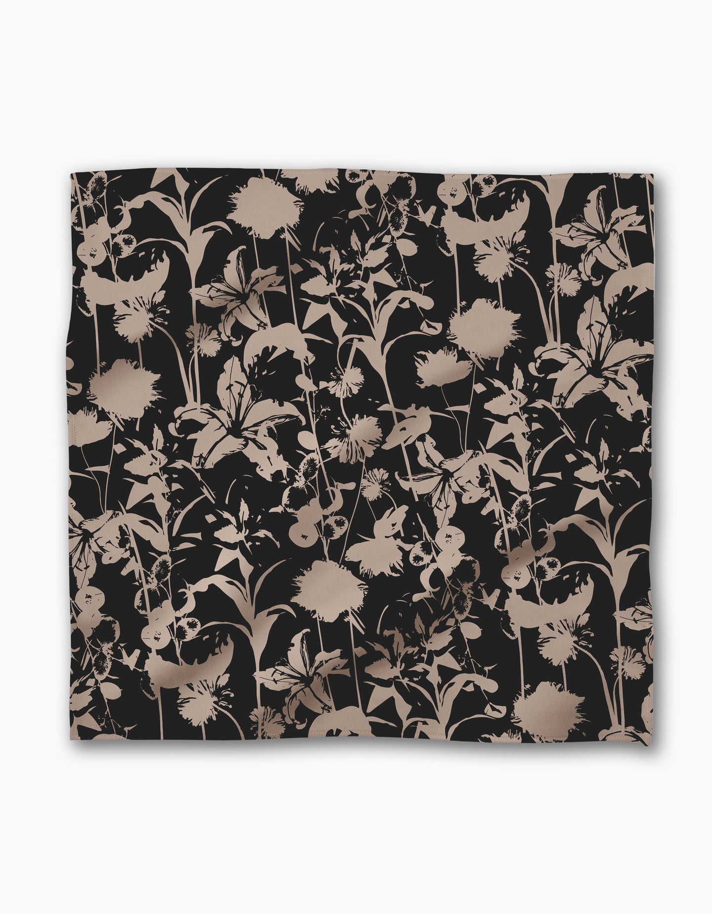 The Geometry Inverted Floral Black blanket showcases a beige and taupe floral silhouette on a black Geosuede fabric, with overlapping flowers and leaves for an elegant look.