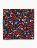 Jewel Leaf Swirl by Rachel Parker features vibrant, multicolored abstract leaves swirling on a dark background—ideal for eco-friendly napkins or a striking recycled dinner napkin set.