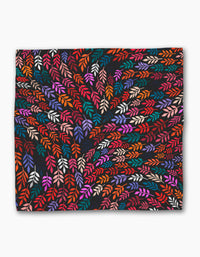 Jewel Leaf Swirl by Rachel Parker features vibrant, multicolored abstract leaves swirling on a dark background—ideal for eco-friendly napkins or a striking recycled dinner napkin set.
