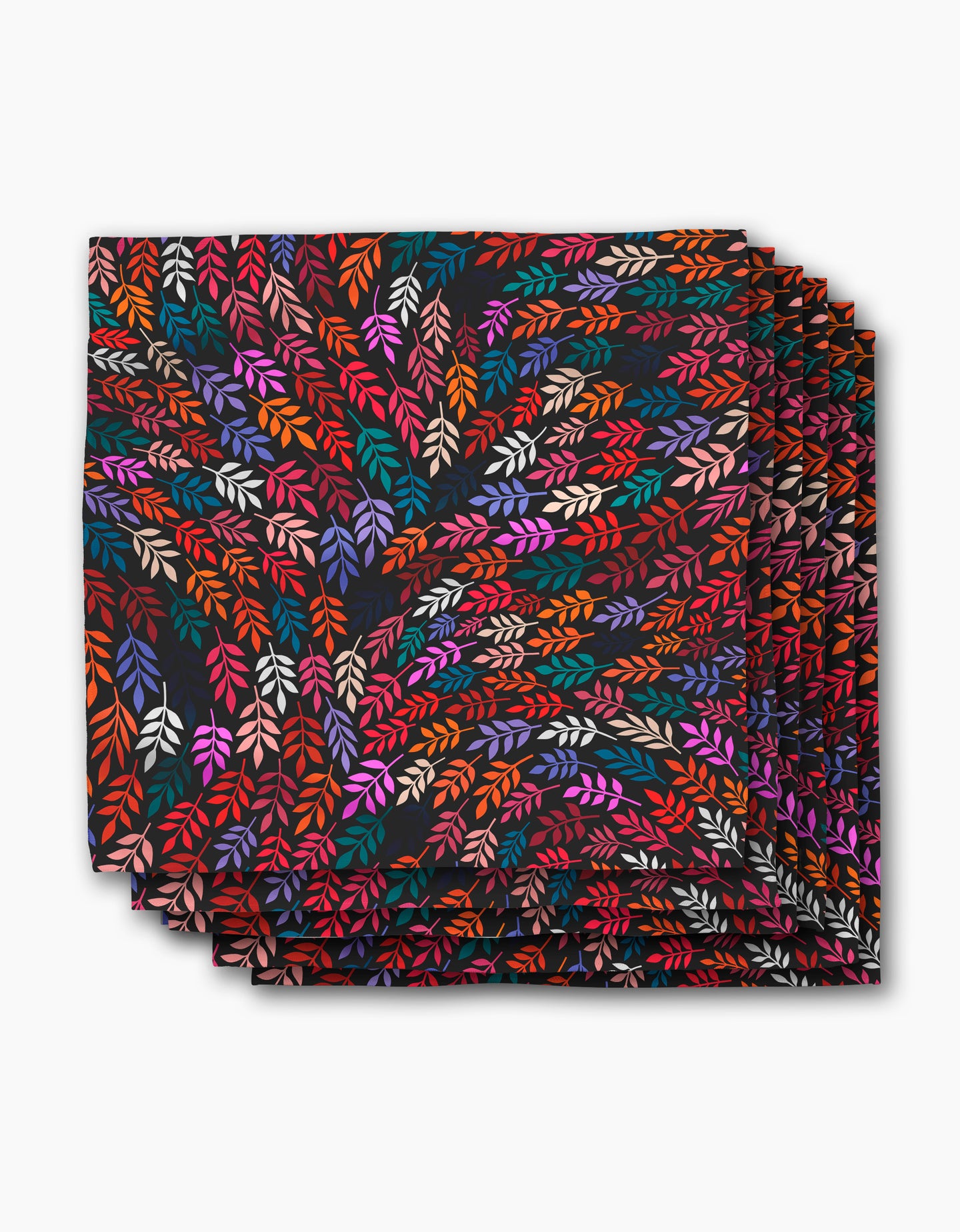 The Rachel Parker Jewel Leaf Swirl dinner napkin features a folded square cloth with vibrant red, orange, pink, purple, and cream leaves swirling on black—an elegant, eco-friendly addition to your napkins collection.
