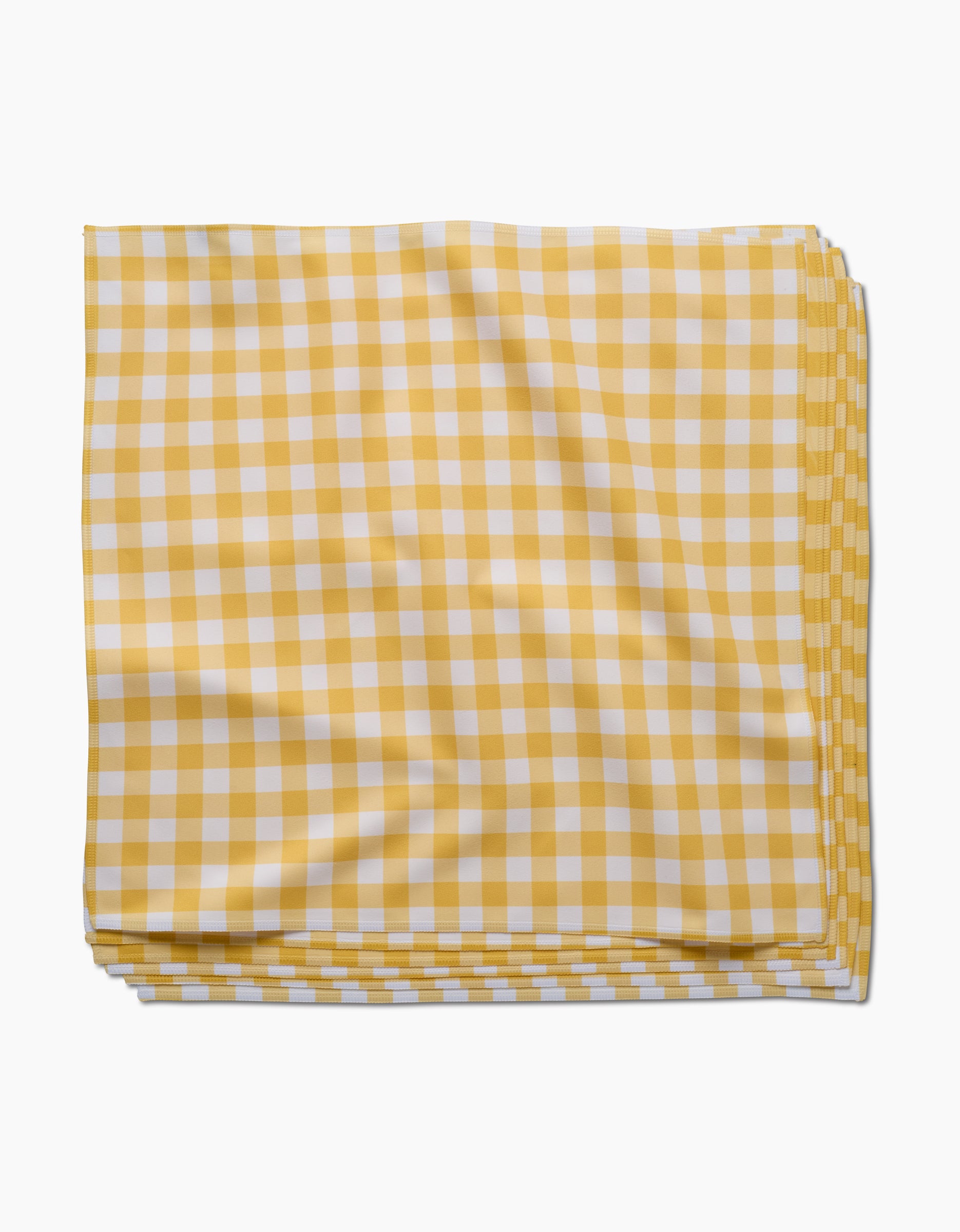 The GEOMETRY Lemon Gingham napkin, crafted from Geosuede fabric in a yellow and white checkered pattern, is neatly folded on a white background.