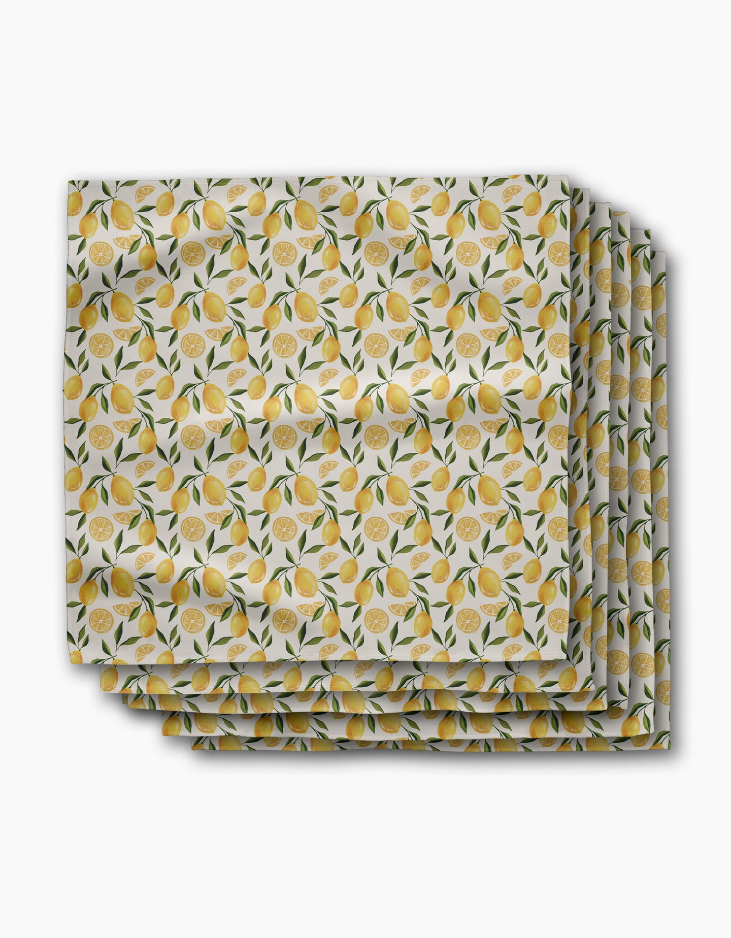 The Limoncello dinner napkins by Geometry feature a repeating lemon, leaf, and slice pattern on white Geosuede fabric. This set of four recycled napkins showcases the same vibrant fruit design on each piece.