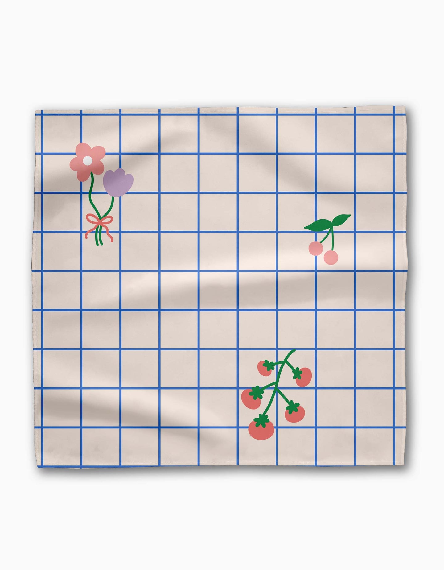 The Mini Harvest Dinner Napkin Set by Letters By Shells features beige fabric with a blue grid pattern, simple pink and purple flower illustrations, cherries, and tomato vines. Slightly wrinkled, this sustainable table linen adds charm to any setting.