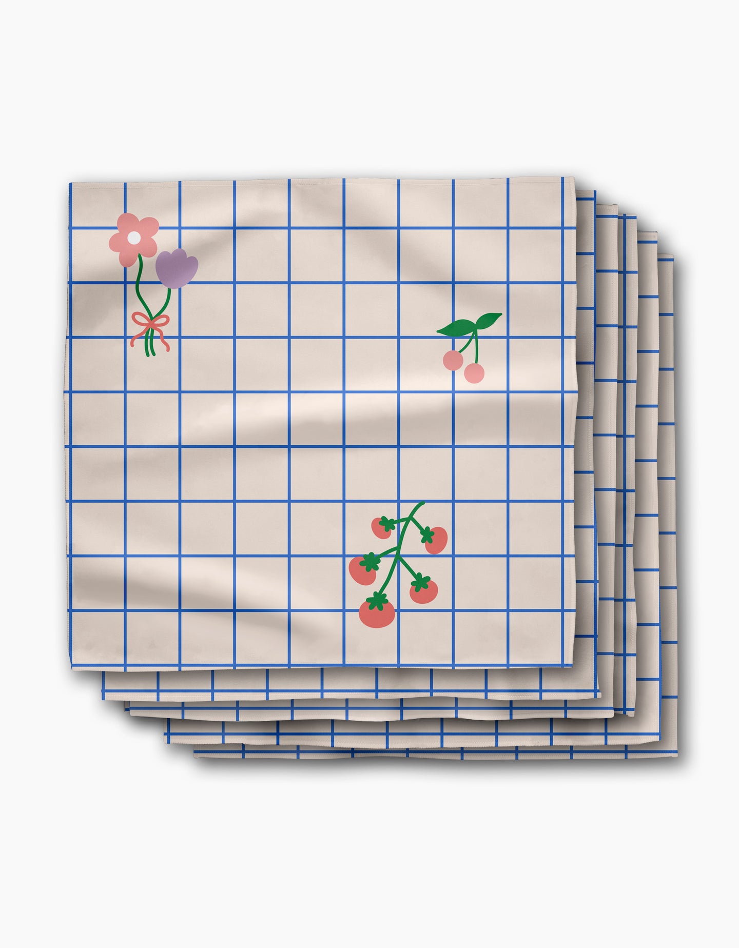 The Mini Harvest dinner napkin set by Letters By Shells features cream-colored Geosuede recycled fabric with a blue grid and charming flower, cherry, and tomato illustrations.
