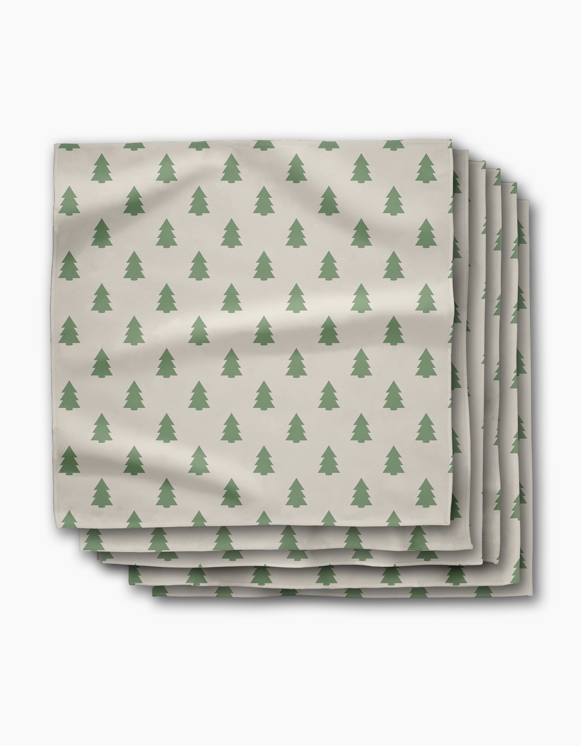 The Kailee Wright "Mini Trees" set features four folded absorbent cloth napkins, each with a repeating pattern of small green pine trees, neatly stacked against a white background.