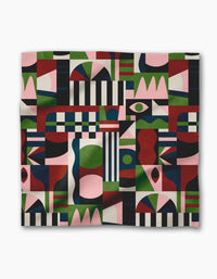 The Modern Bauhaus Mood blanket by Claire Iglesias features a colorful, abstract design with geometric shapes—stripes, circles, and rectangles—in red, green, navy, black, and pink. Made from recycled materials for a modern artistic look.