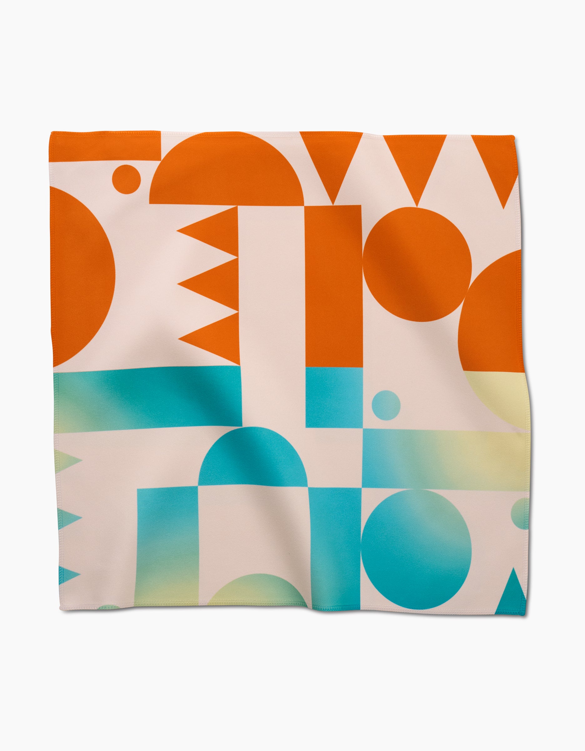 The Moody Shapes napkin set by GEOMETRY is made from Geosuede fabric and features an abstract geometric pattern in orange, turquoise, light blue, and yellow with circles, triangles, rectangles, and arches on white.
