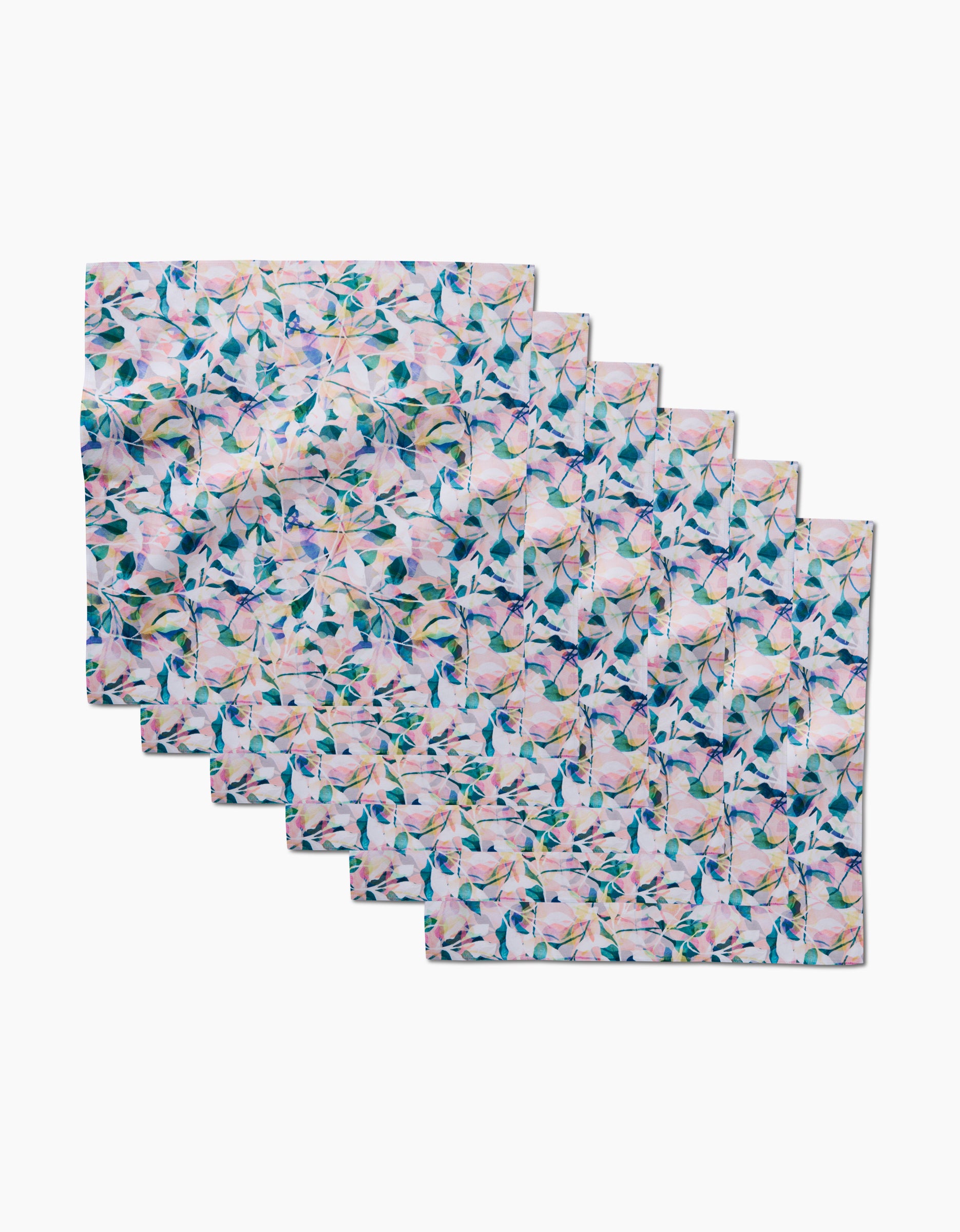 The Painted Foliage Dinner Napkin Set by Rachel Parker includes eight eco-friendly napkins, each featuring a pastel floral design with green leaves and pink flowers on a light background—ideal for any table setting.