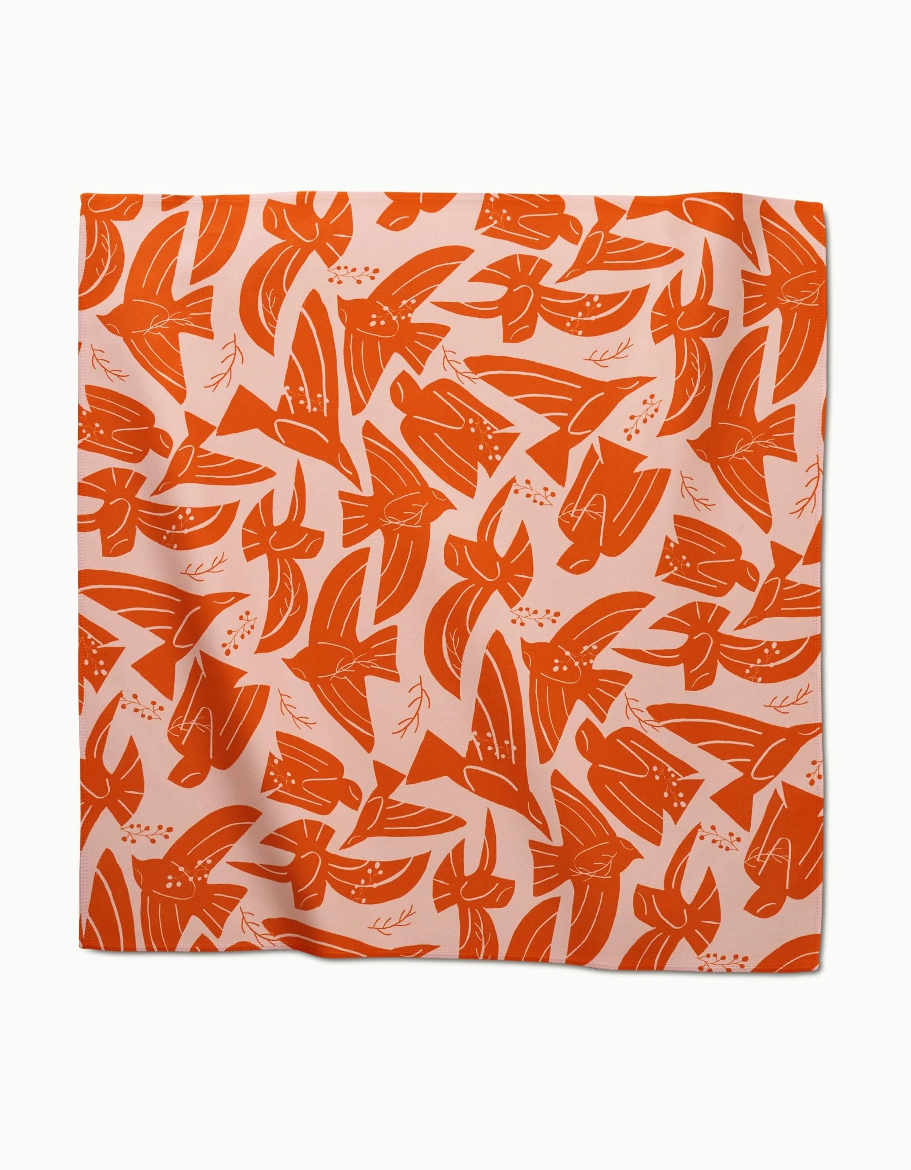 The Ash Cascade Peace Bird square scarf features an orange and white abstract floral pattern, ideal for adding a stylish touch to your table when paired with absorbent dinner napkins.