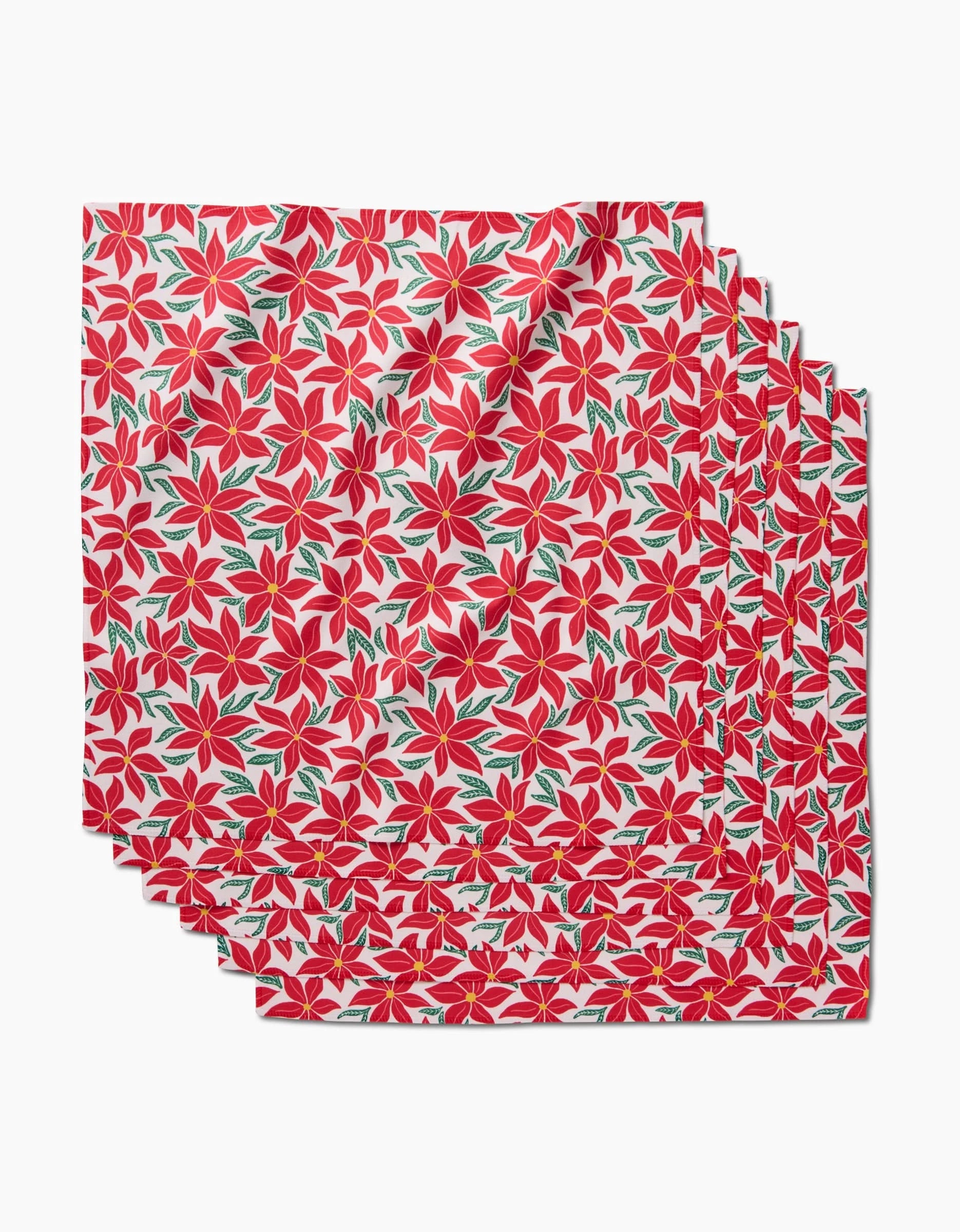 The Kayla Ann Poinsettia Party Dinner Napkin Set includes four absorbent napkins with a red poinsettia and green leaf pattern on a white background, displayed in a fanned-out stack.
