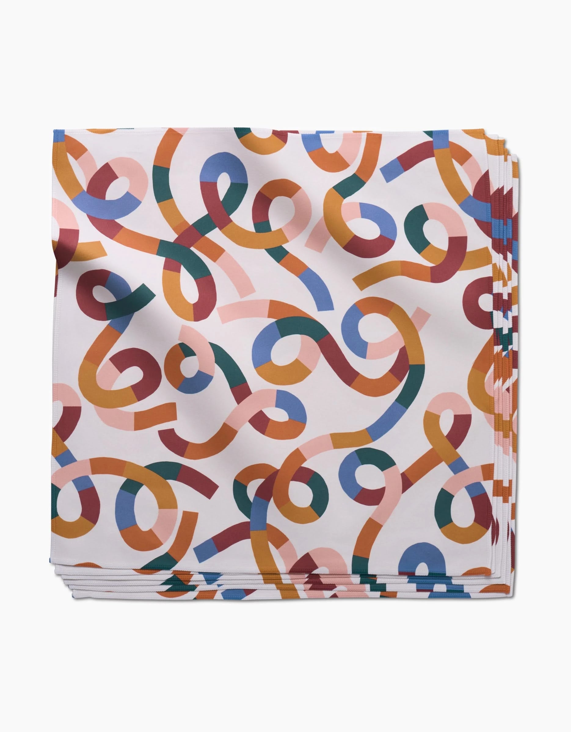 Claire Iglesias’s Rainbow Squiggles dinner napkins feature a colorful abstract pattern of overlapping curved lines in orange, blue, pink, green, and red on white—an eco-friendly addition to your table.