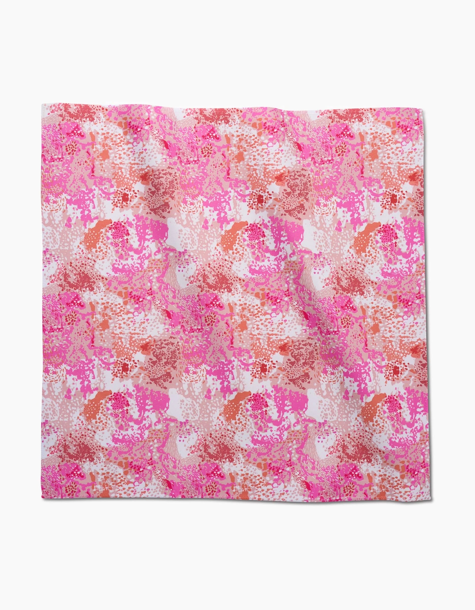 The Elisabeth Wing Rawhide dinner napkin is a square Geosuede fabric with an abstract floral pattern in pink, red, and orange on white, featuring a textured painterly style and made from recycled materials.