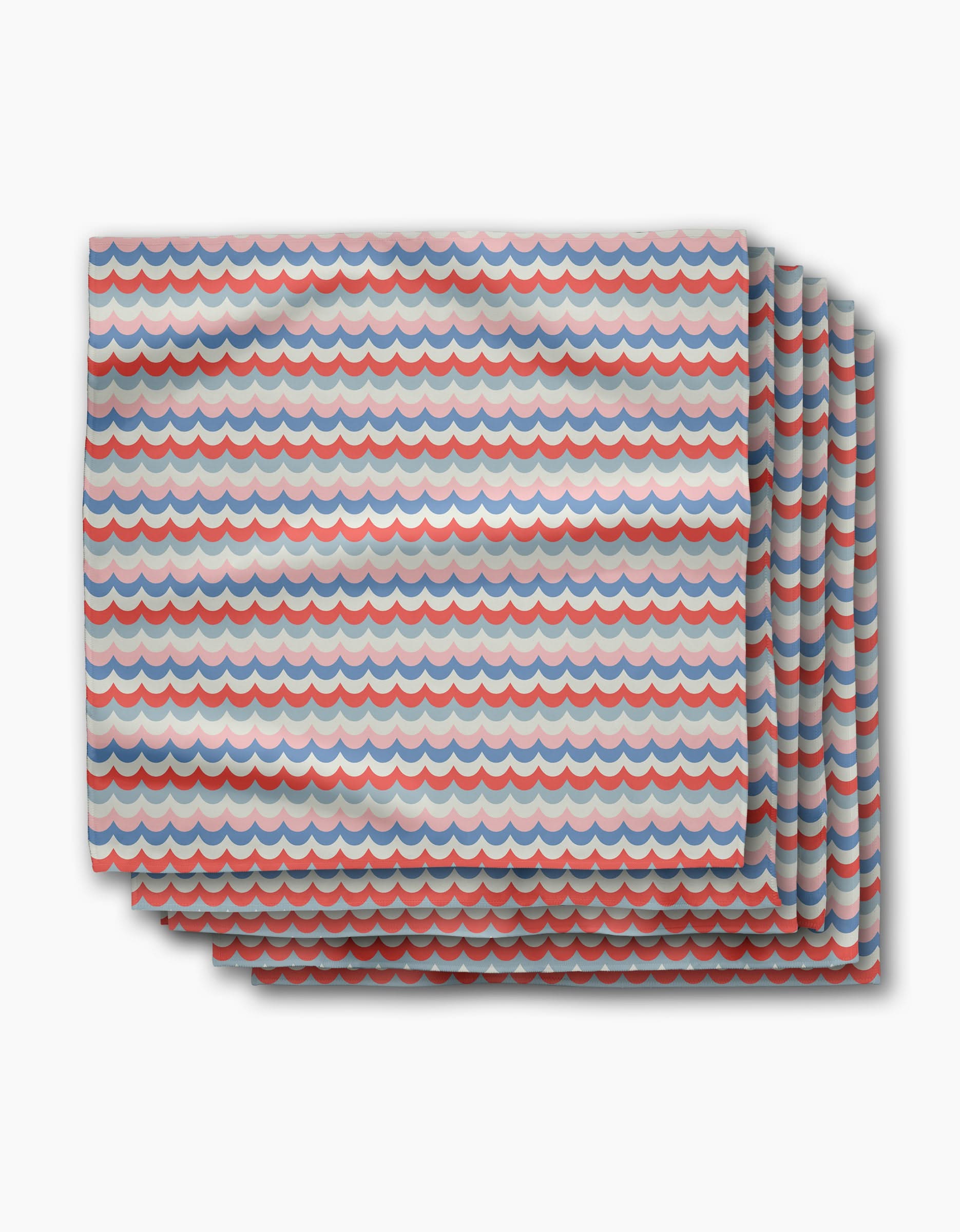 Four folded Scallop Stripes dinner napkins by Geometry, made from recycled Geosuede fabric with a blue, red, and white wave pattern. Stacked slightly offset on a white background—eco-friendly and stylish for any table.