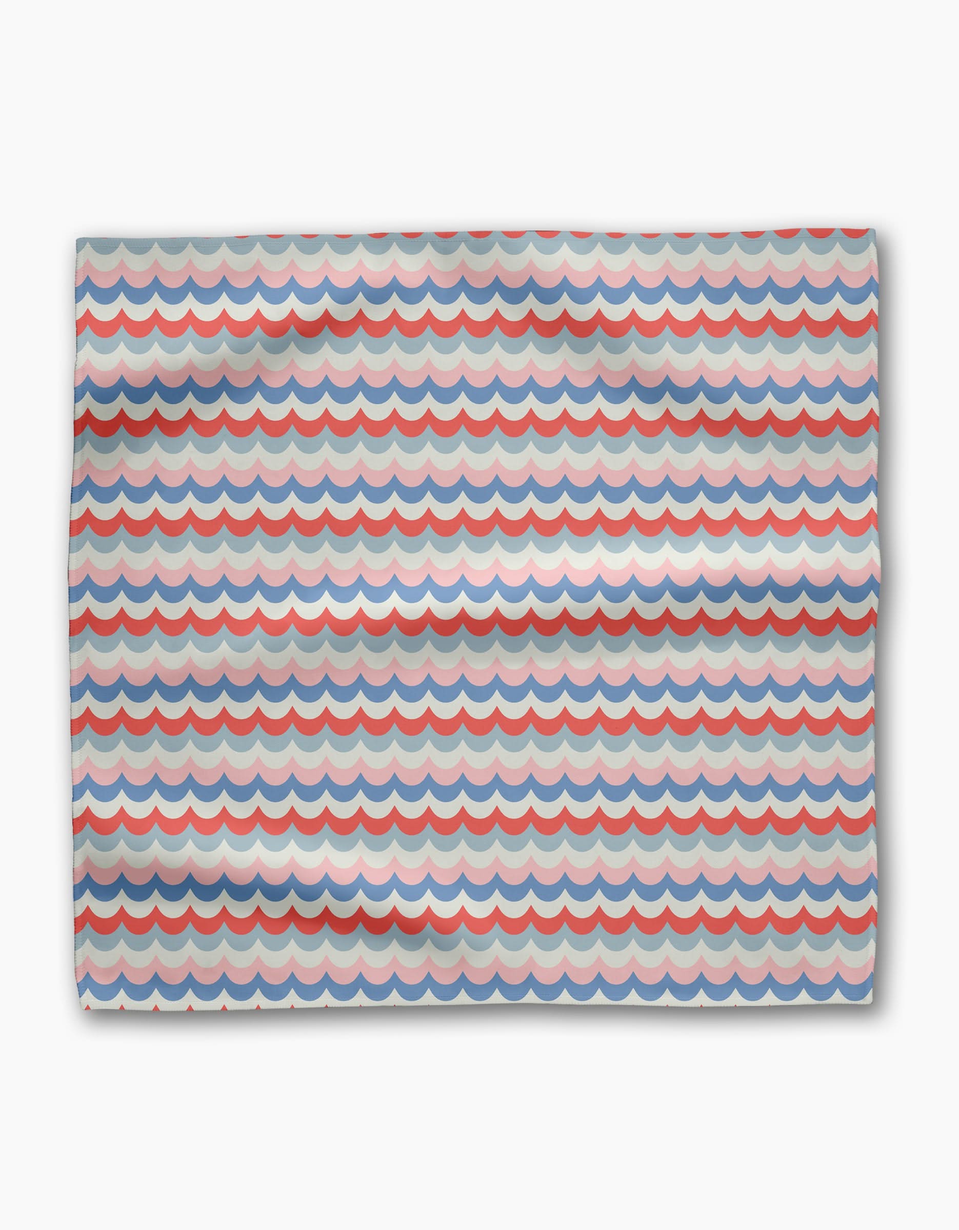 The Geometry Scallop Stripes dinner napkin is made from recycled Geosuede fabric with a red, blue, and gray scallop wave pattern on white, featuring horizontal rows of semi-circular shapes.