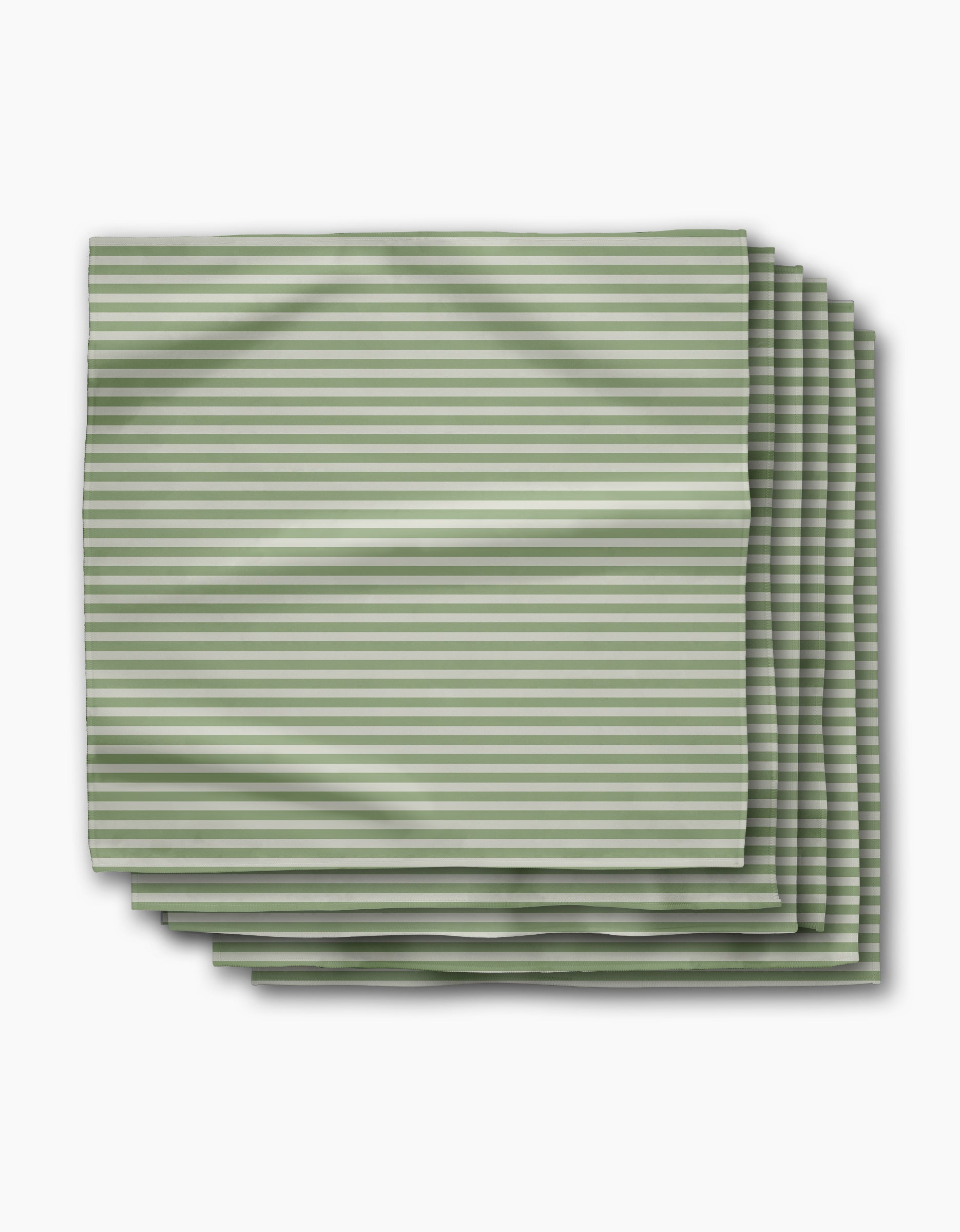 Geometry’s Seagrass Dinner Napkin Set includes four neatly folded cloth napkins made from recycled materials, featuring thin green and white horizontal stripes on a white background.