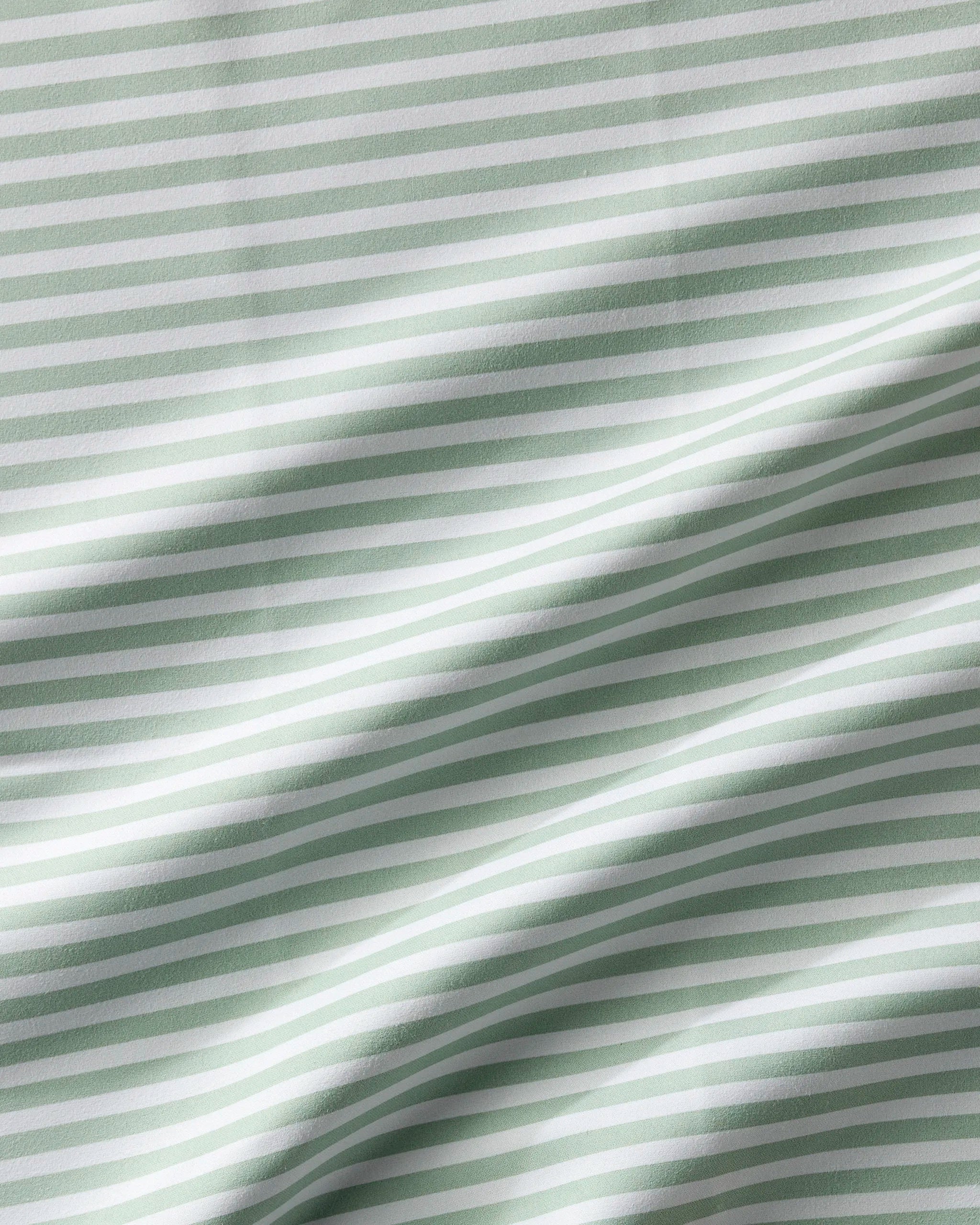 Seagrass by Geometry features light green and white horizontal stripes with gentle folds and soft shadows, creating a wavy texture—ideal for absorbent cloth napkins in your Dinner Napkin Set.