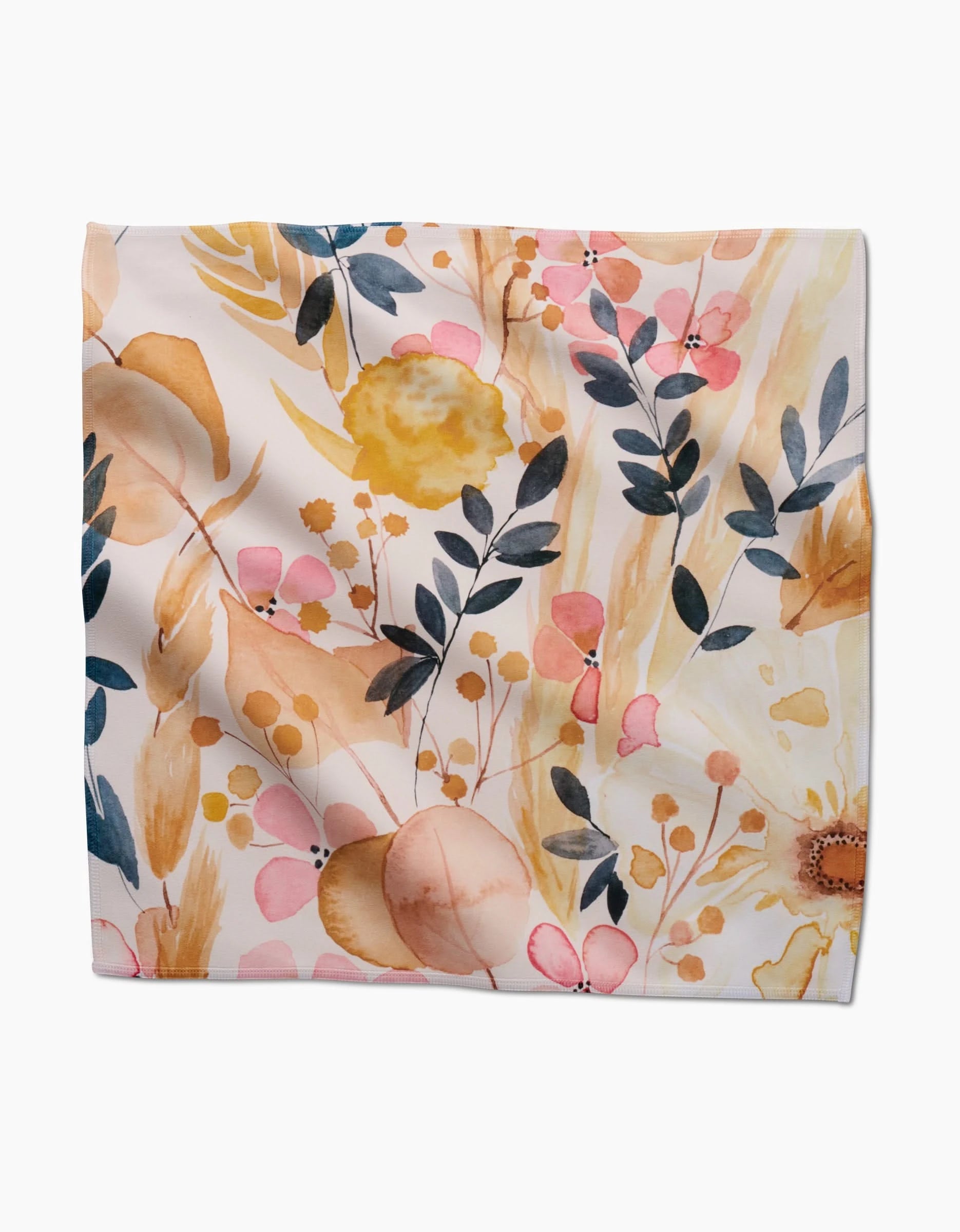 The Sleepy Fields square scarf by GEOMETRY is made from soft Geosuede fabric and showcases a watercolor floral design with yellow, peach, pink, and white blooms plus dark green and blue leaves on a light background.