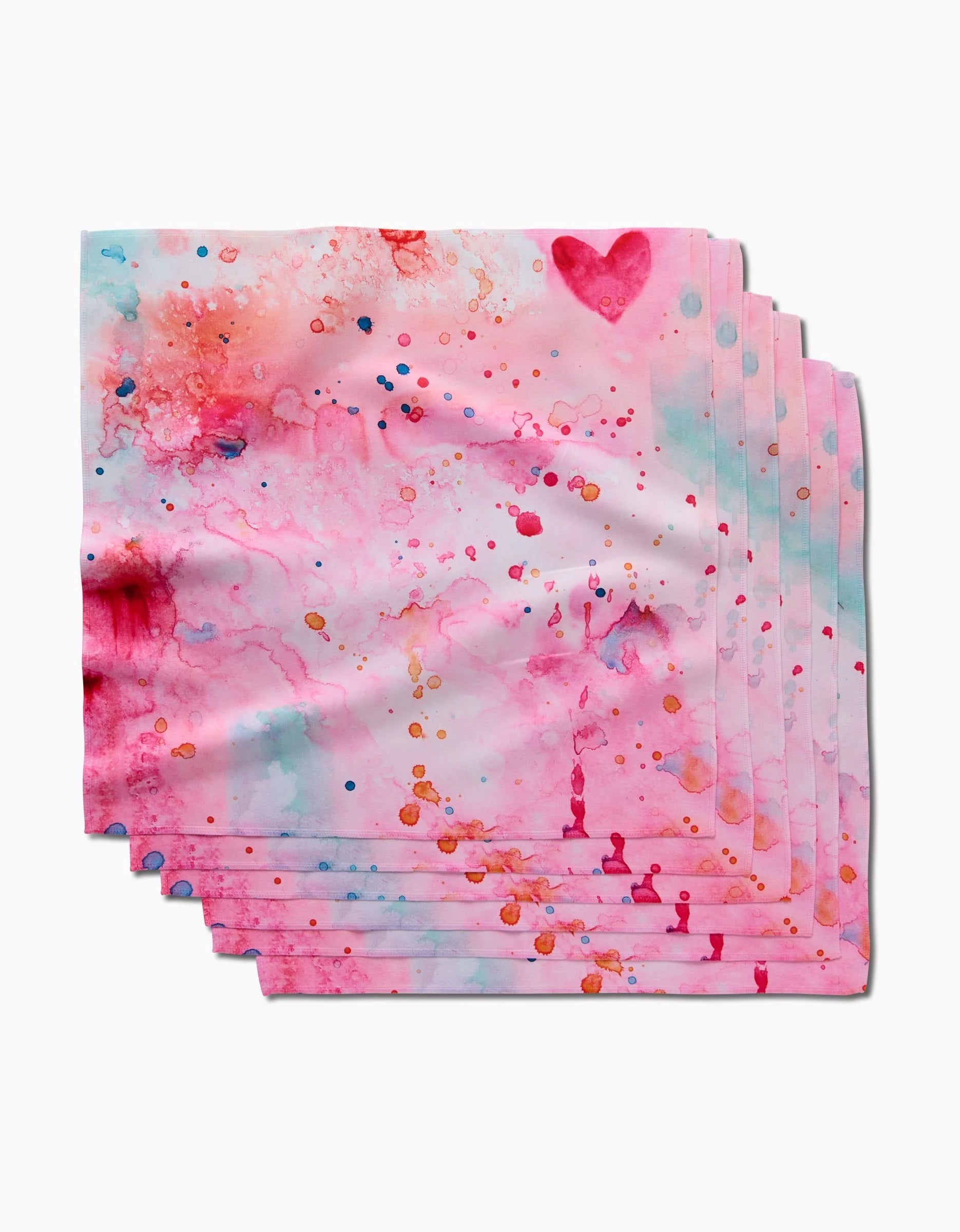 Sara Maris Splash of Love dinner napkins feature a white background with a pink watercolor design, colorful splashes of blue, red, and orange, and a pink heart in the upper right corner.