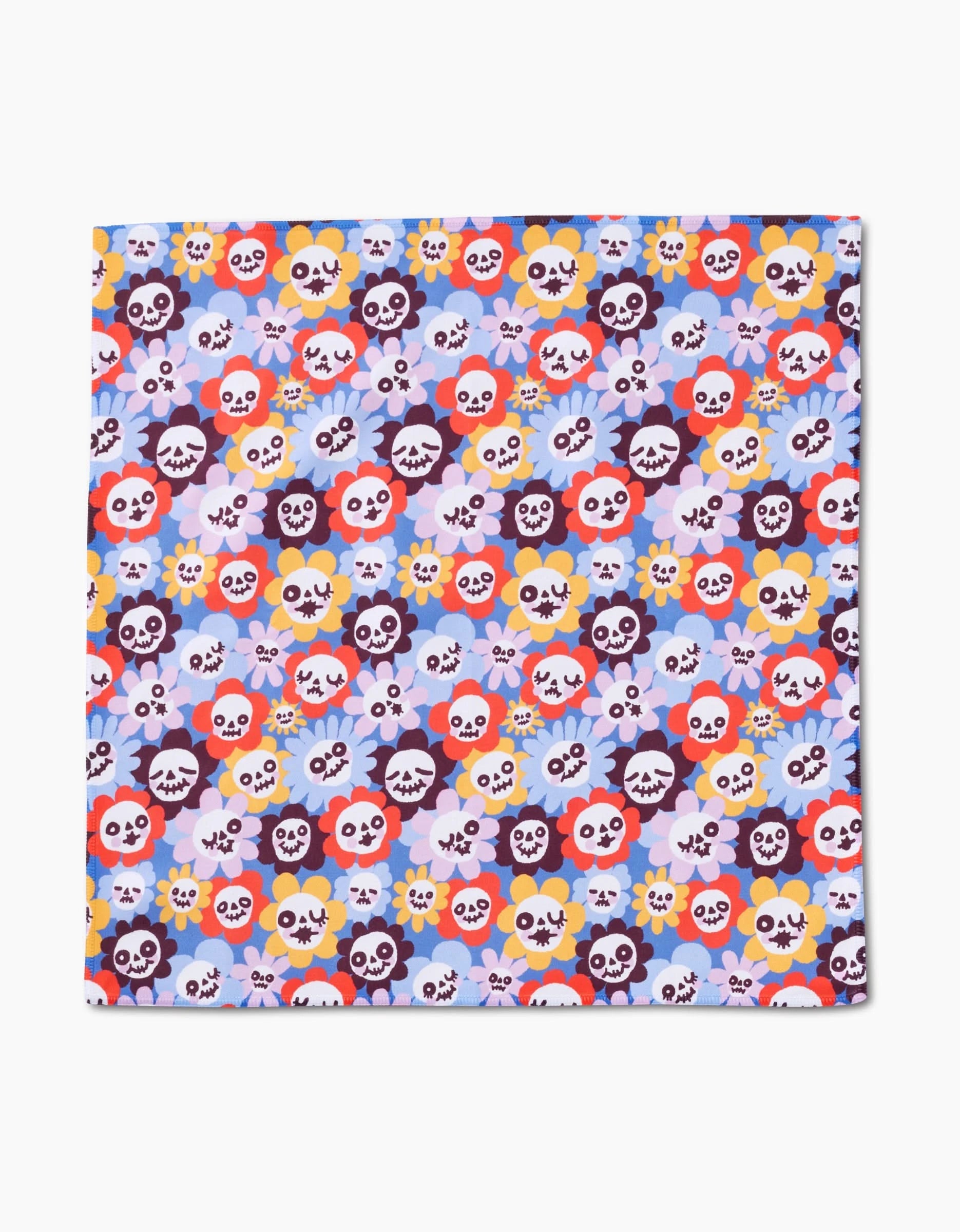 The Spooky Bouquet by So Lazo is a square Geosuede dinner napkin with recycled materials, decorated with colorful cartoon skulls and flowers on a light blue background for an eco-friendly touch.