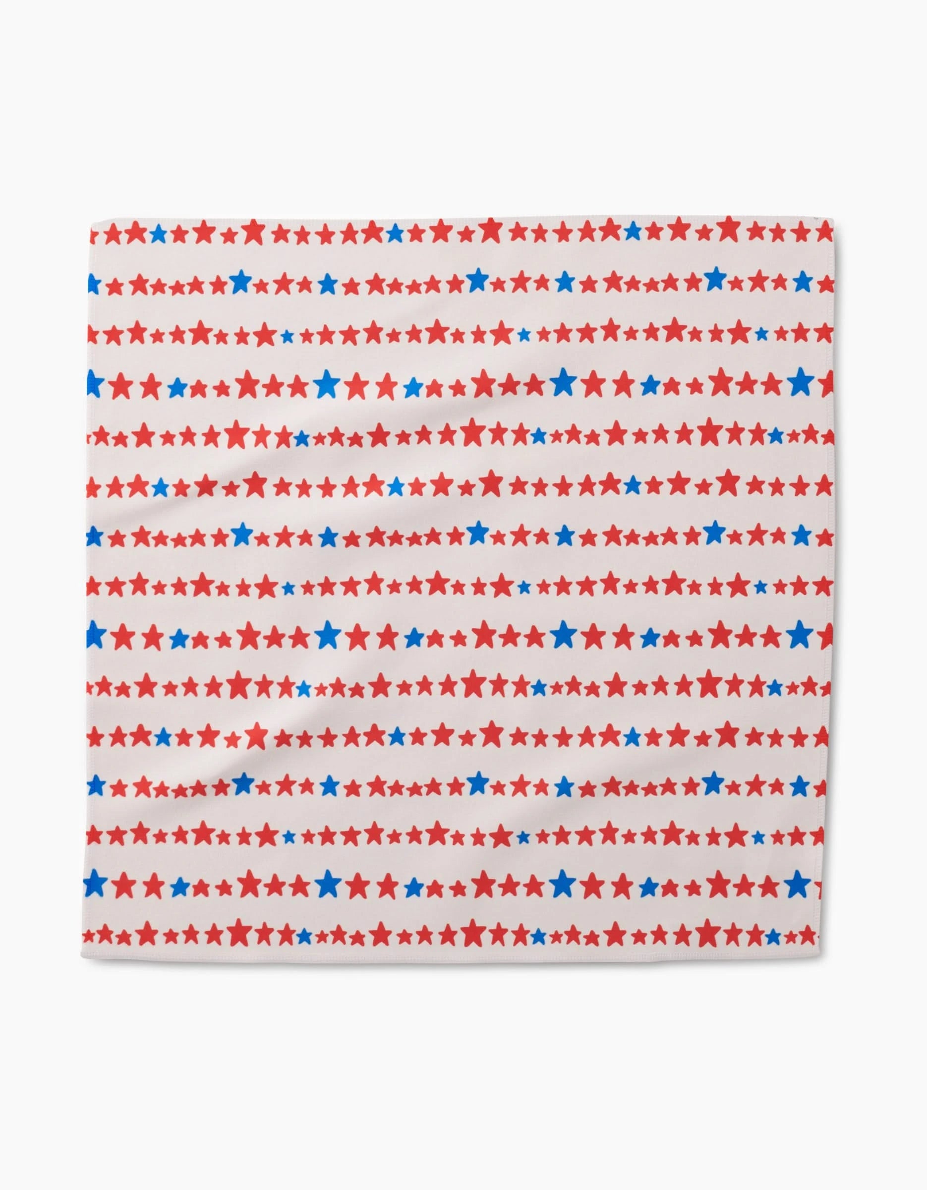 The Kayla Ann Starry Stripes Dinner Napkin features alternating rows of red and blue stars on white, crafted from recycled materials for a festive, patriotic look.