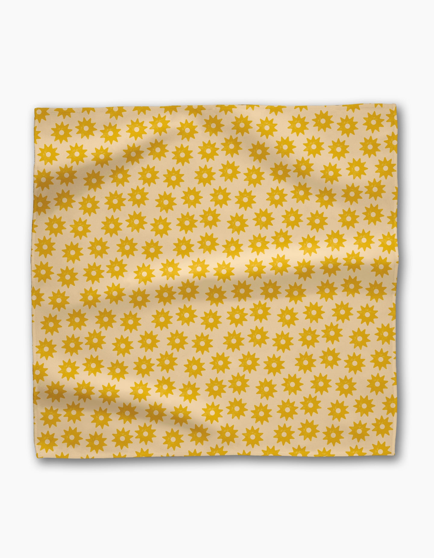 Geometry’s Sunny Sun Dinner Napkin Set features square, cream-colored fabric napkins with a repeating pattern of small yellow sun shapes. These eco-friendly napkins have a slightly wrinkled, charming, and natural appearance.