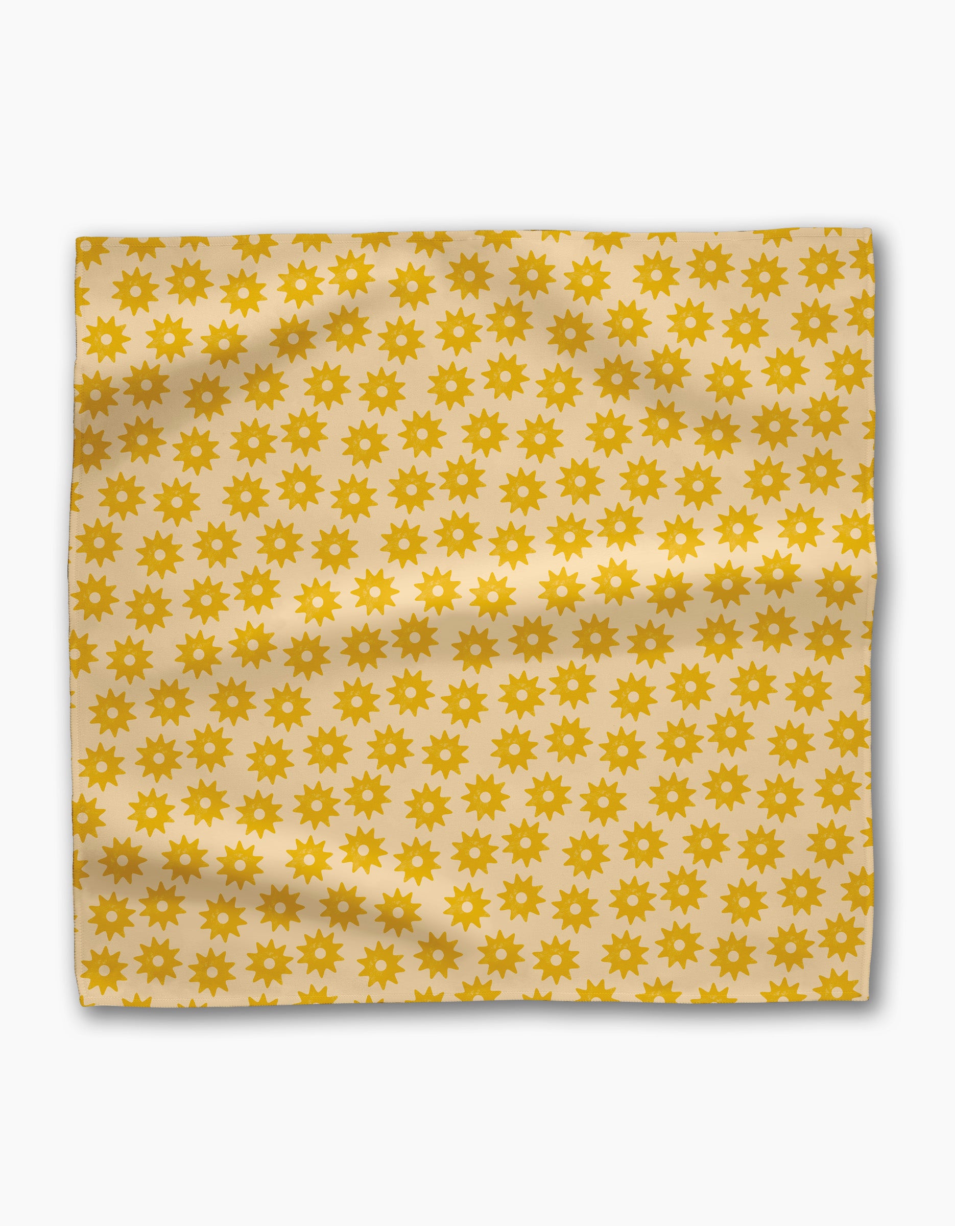 Geometry’s Sunny Sun Dinner Napkin Set features square, cream-colored fabric napkins with a repeating pattern of small yellow sun shapes. These eco-friendly napkins have a slightly wrinkled, charming, and natural appearance.