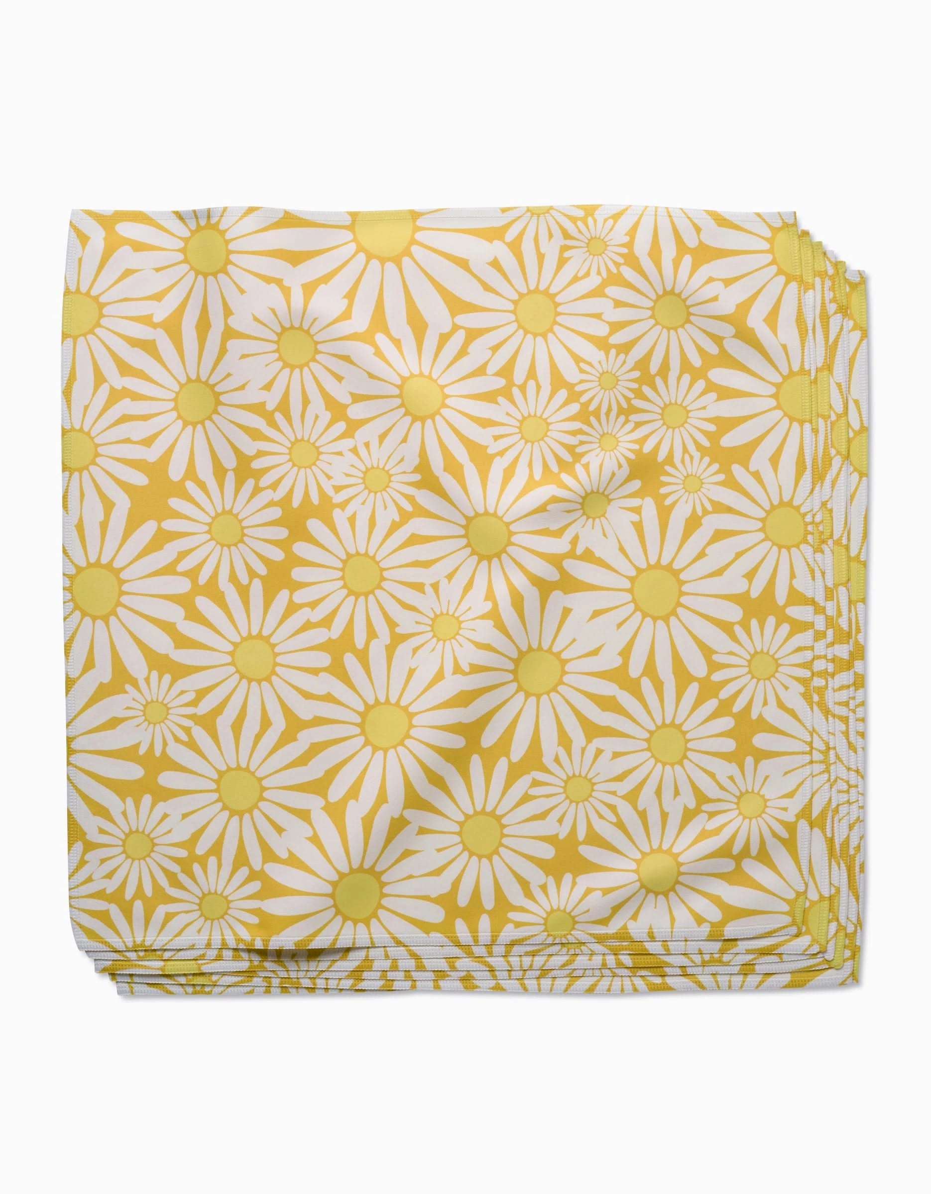 Sunshine Meadow by Rebecca Bobko: Folded Geosuede fabric with a bright, cheerful floral print of yellow and white daisies with yellow centers on a white background.