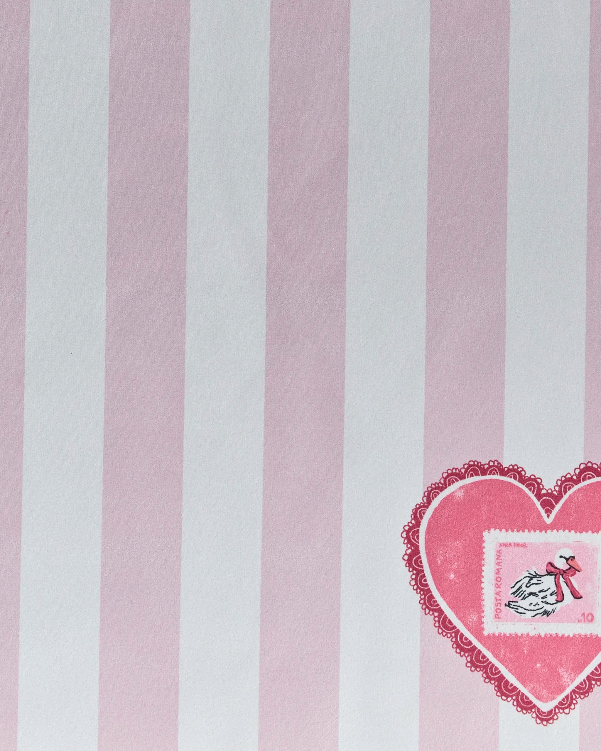 Geometry’s “Swan and Stripes” napkin set features vertical pink and white stripes, a pink lace-edged heart with a flying bird stamp and red ribbon—an eco-friendly choice for your table.