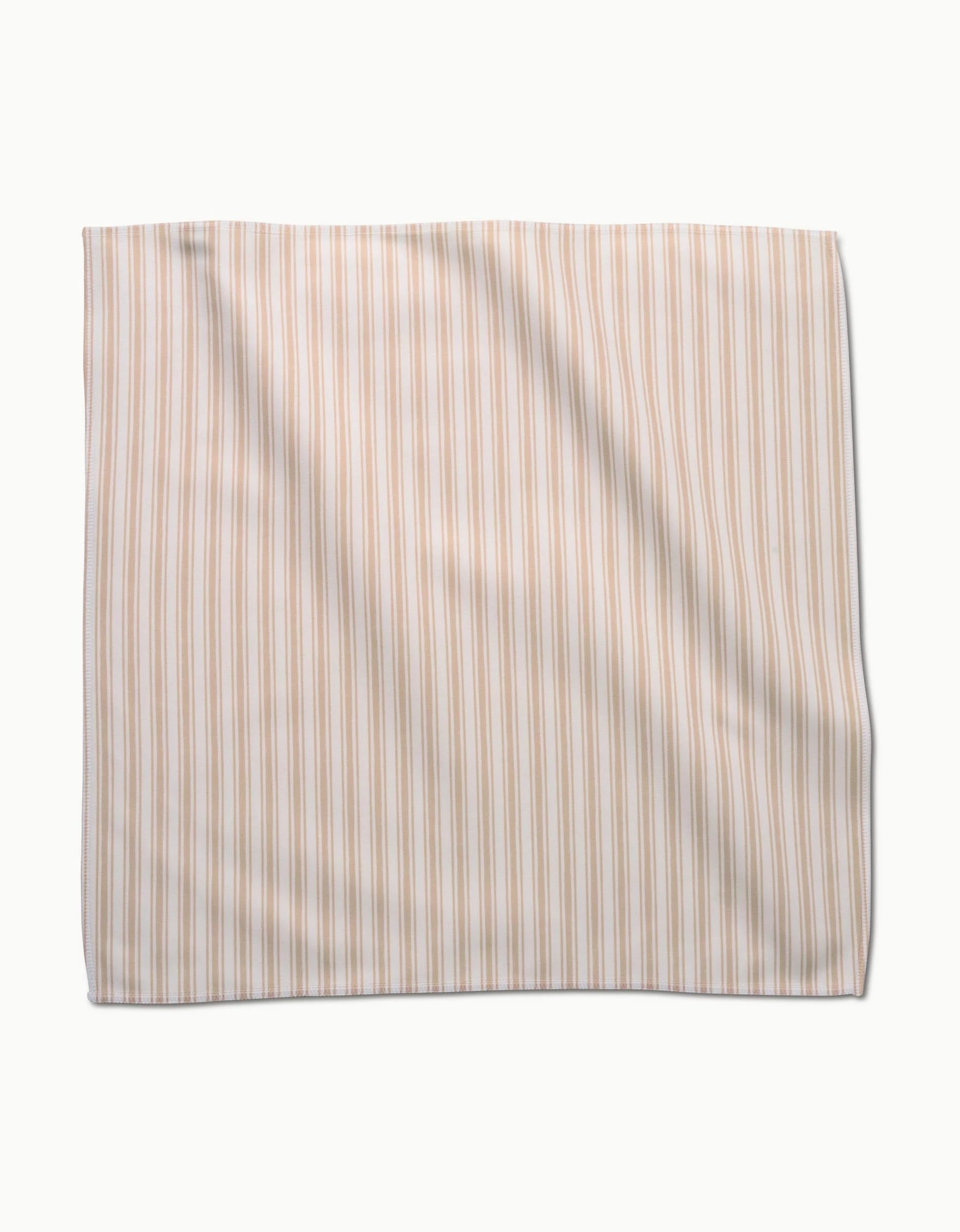 The Sweet Boho rectangular fabric dinner napkin set by Hufton Studio features vertical beige and white stripes, shown flat on a white background with slight folds and wrinkles.