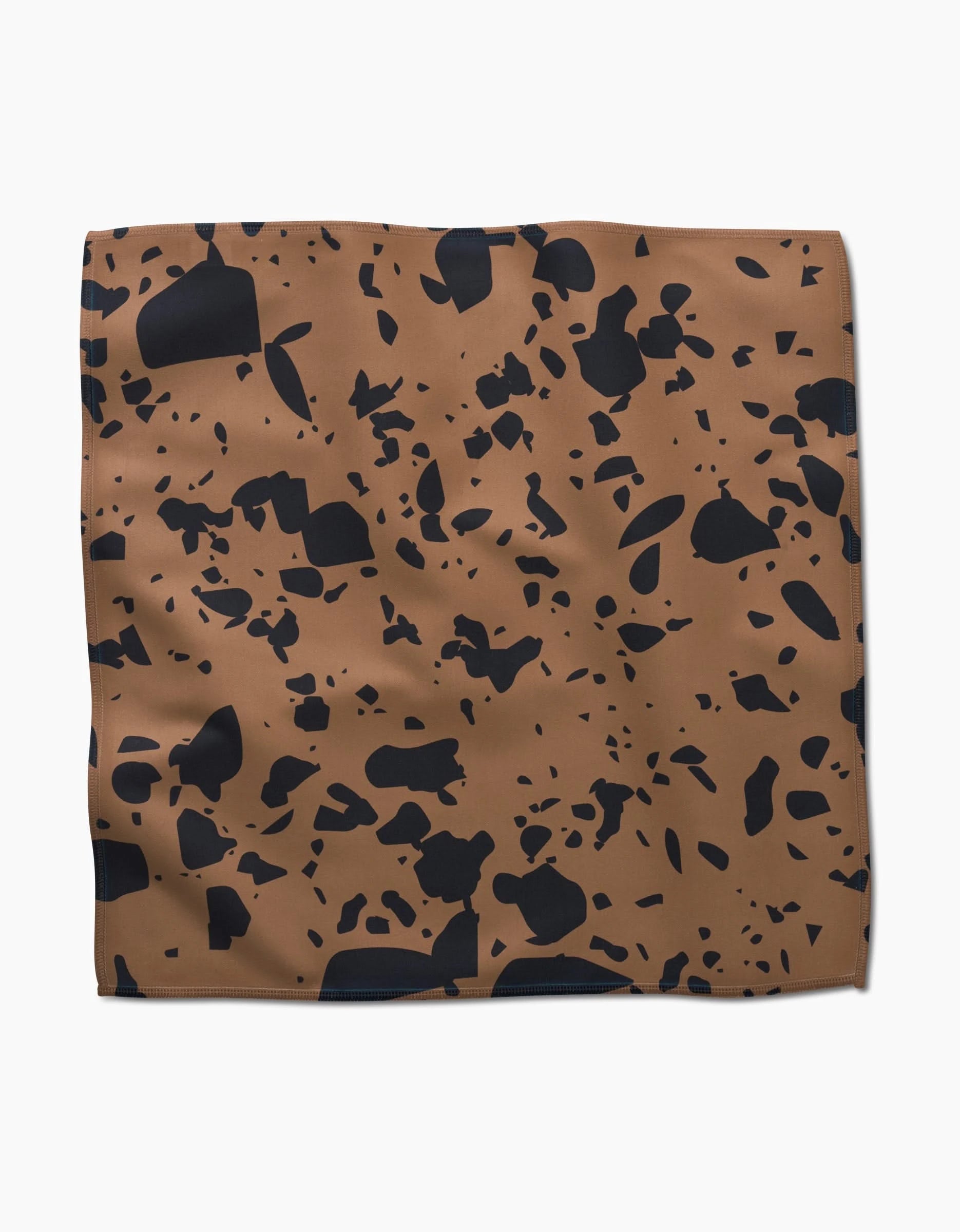 The Terrazo square brown absorbent cloth napkin by GEOMETRY features an abstract black speckled pattern and is displayed on a plain white background.
