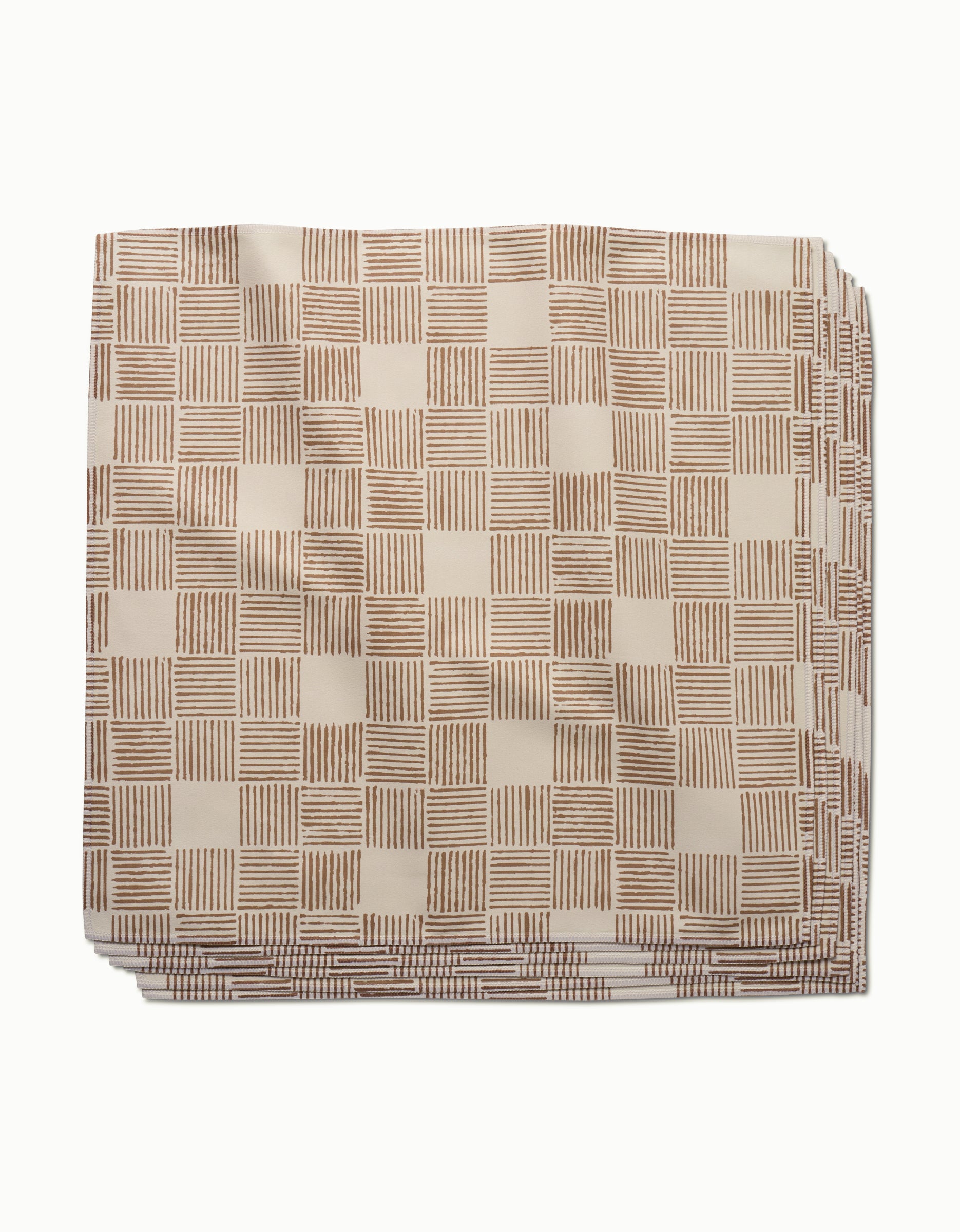 The Thatcher napkin by Studio Jeannot is a neatly folded beige cloth napkin made from premium Geosuede, featuring a checkered pattern with horizontal and vertical brown stripes.