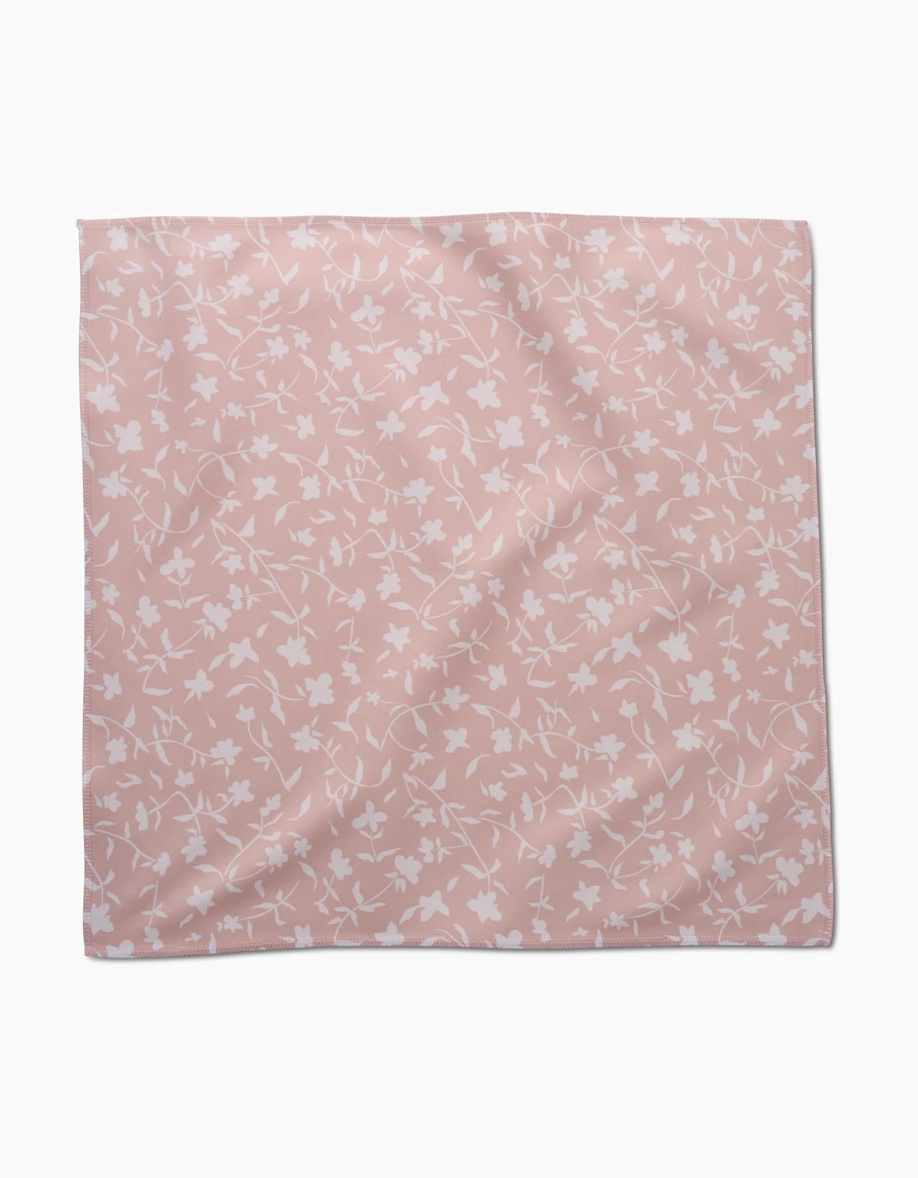 The Aubrey Fairchild Tiny Floral scarf in light pink Geosuede Fabric features a delicate white floral pattern evenly scattered across its square shape, shown flat on a plain white background.