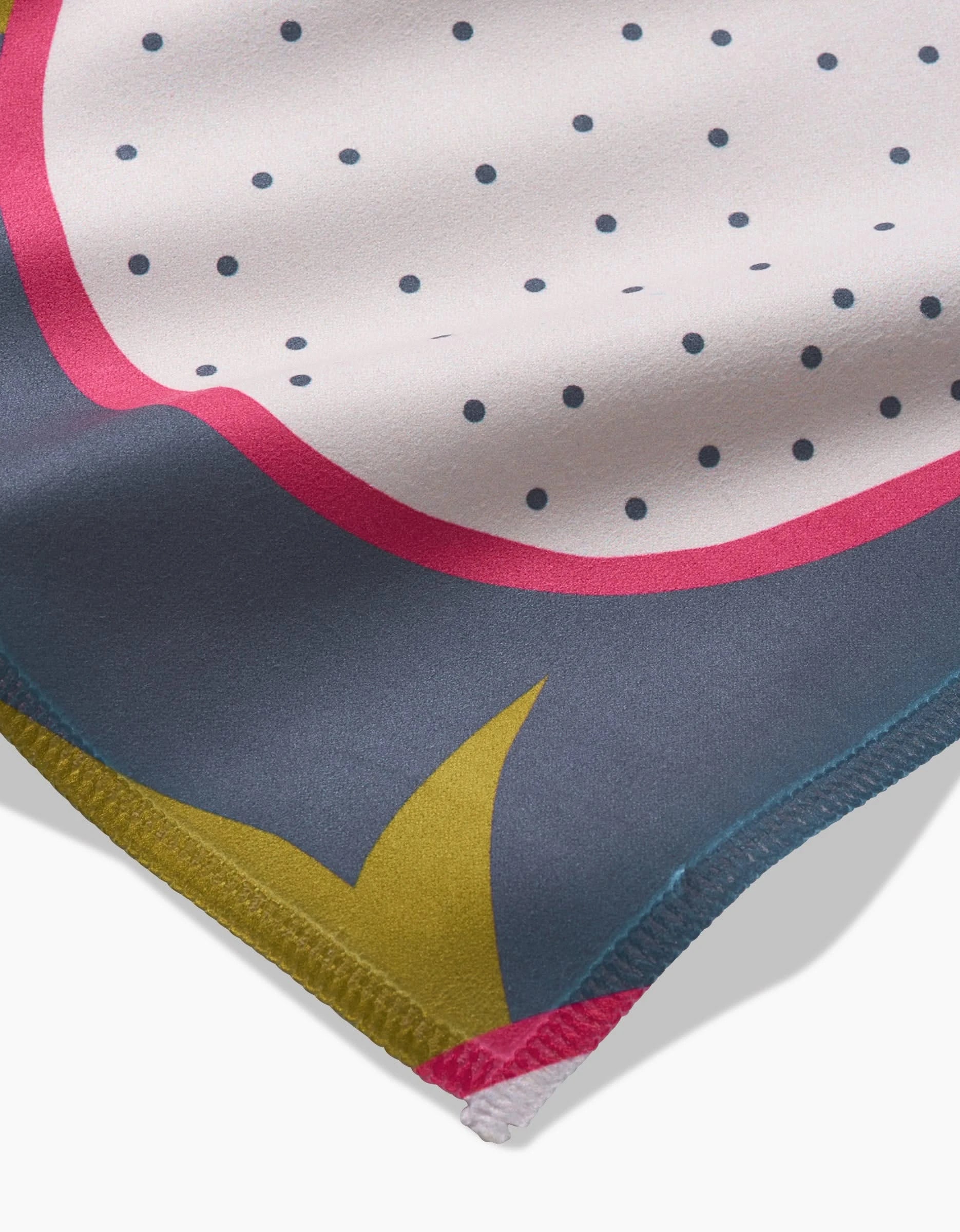 Close-up of Tropical Fruit by Lizzie Clark: a soft Geosuede fabric with a stylized dragon fruit pattern in white, pink, dark blue, yellow, and black polka dots—ideal for vibrant dinner napkin sets.