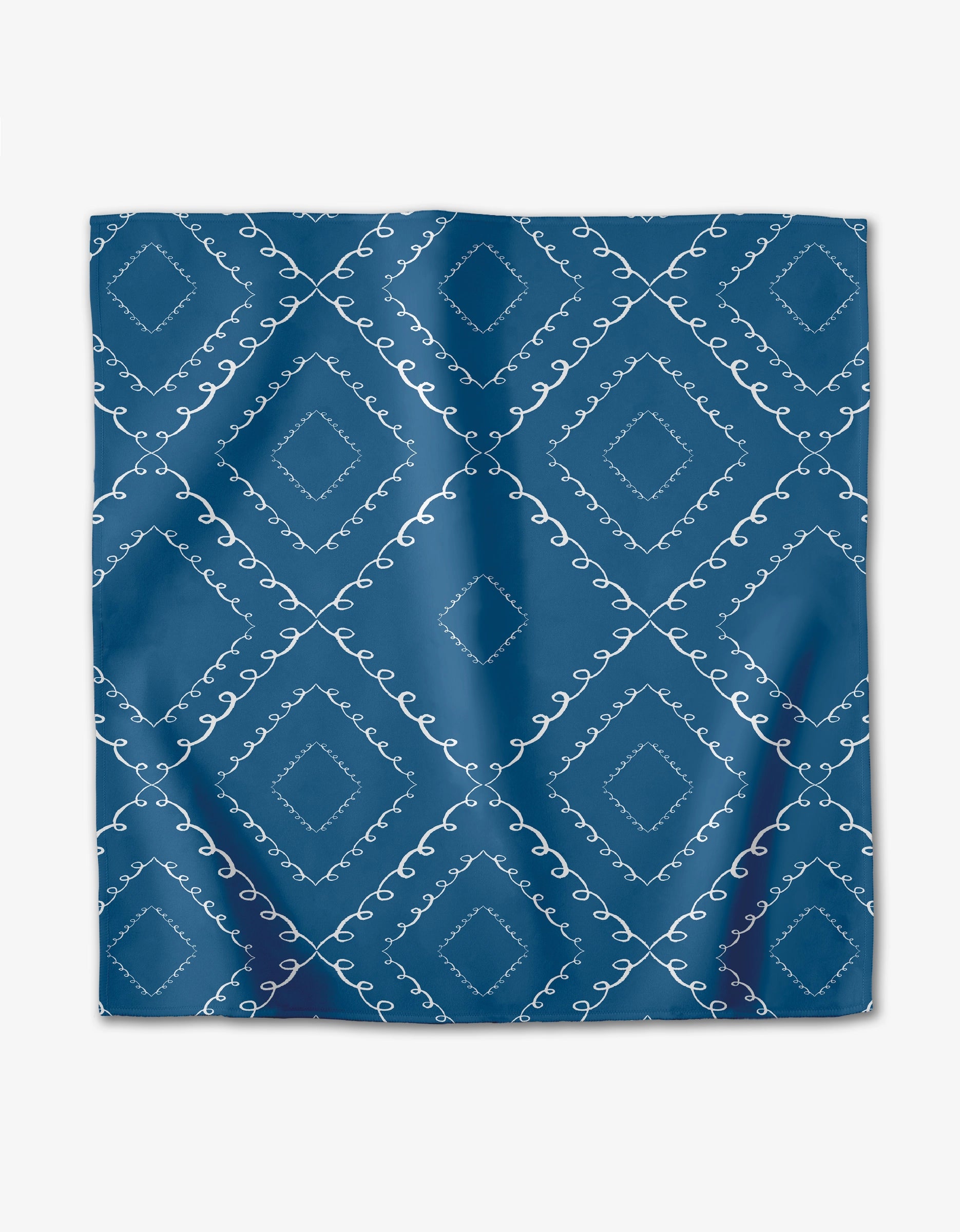 The Elena Fay Twirls set features blue square dinner napkins with a white diamond and swirl pattern in a repeating grid. These absorbent cloth napkins offer a smooth, lightly shiny finish perfect for elegant dining.